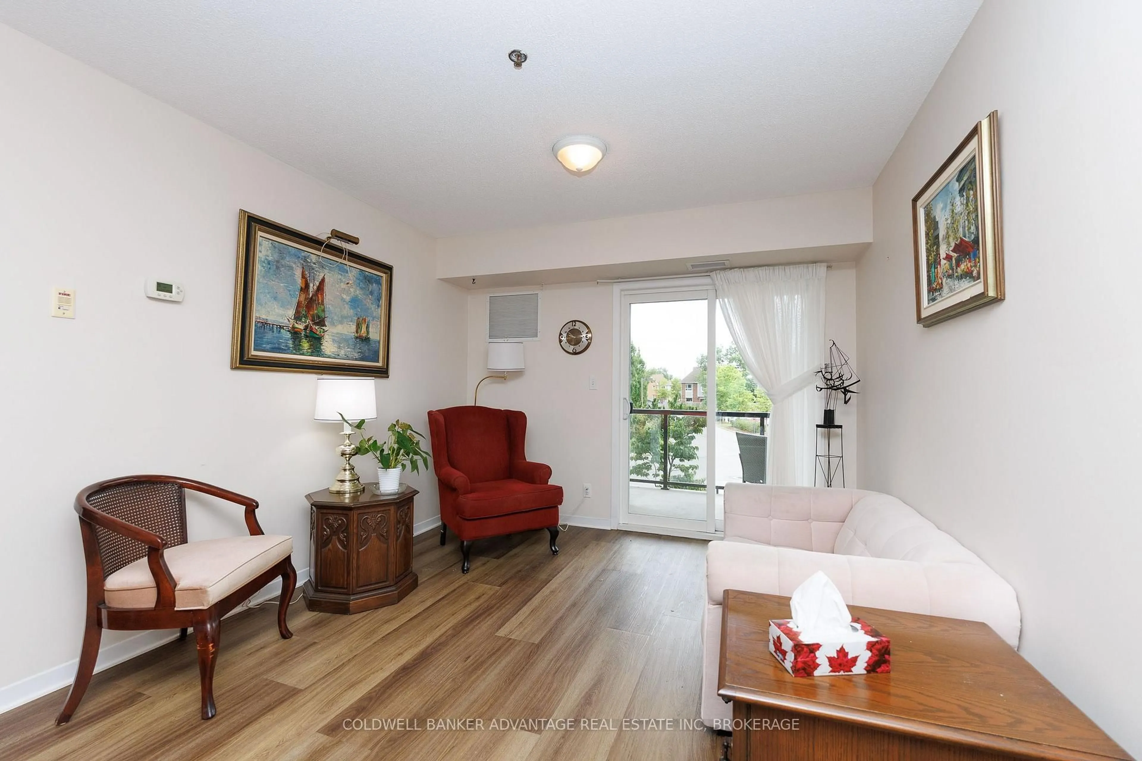 Living room with furniture, wood/laminate floor for 330 Prince Charles Dr #1208, Welland Ontario L3C 7B3
