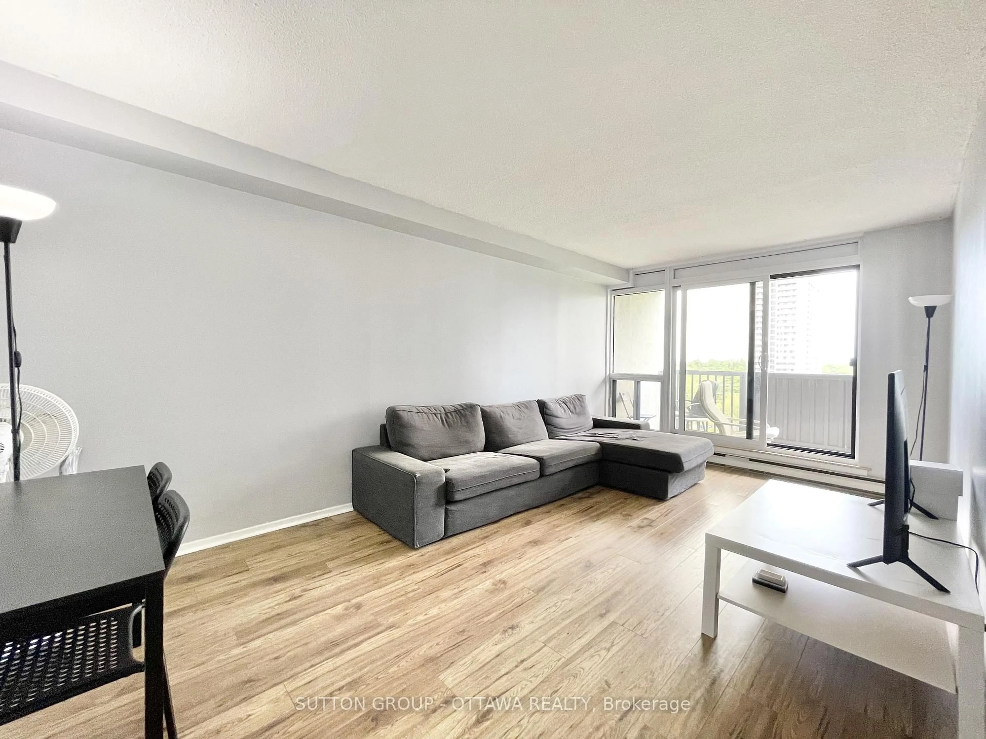 Living room with furniture, wood/laminate floor for 900 Dynes Rd #704, Ottawa Ontario K2C 3L6