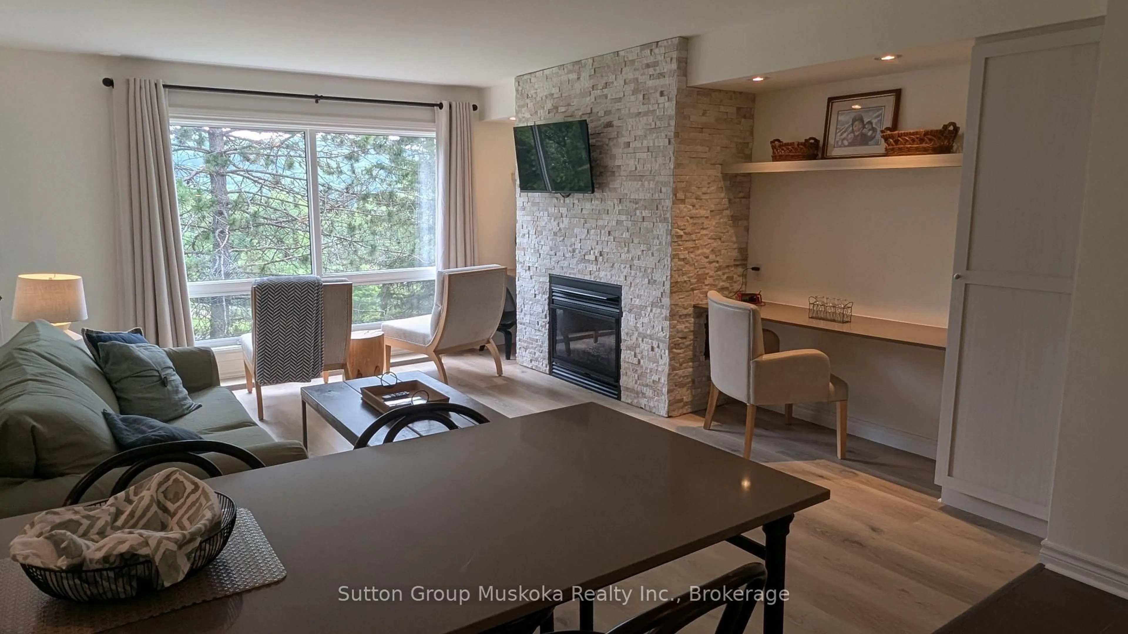 Living room with furniture, wood/laminate floor for 52-205 Deerhurst Dr, Huntsville Ontario P1H 2E8
