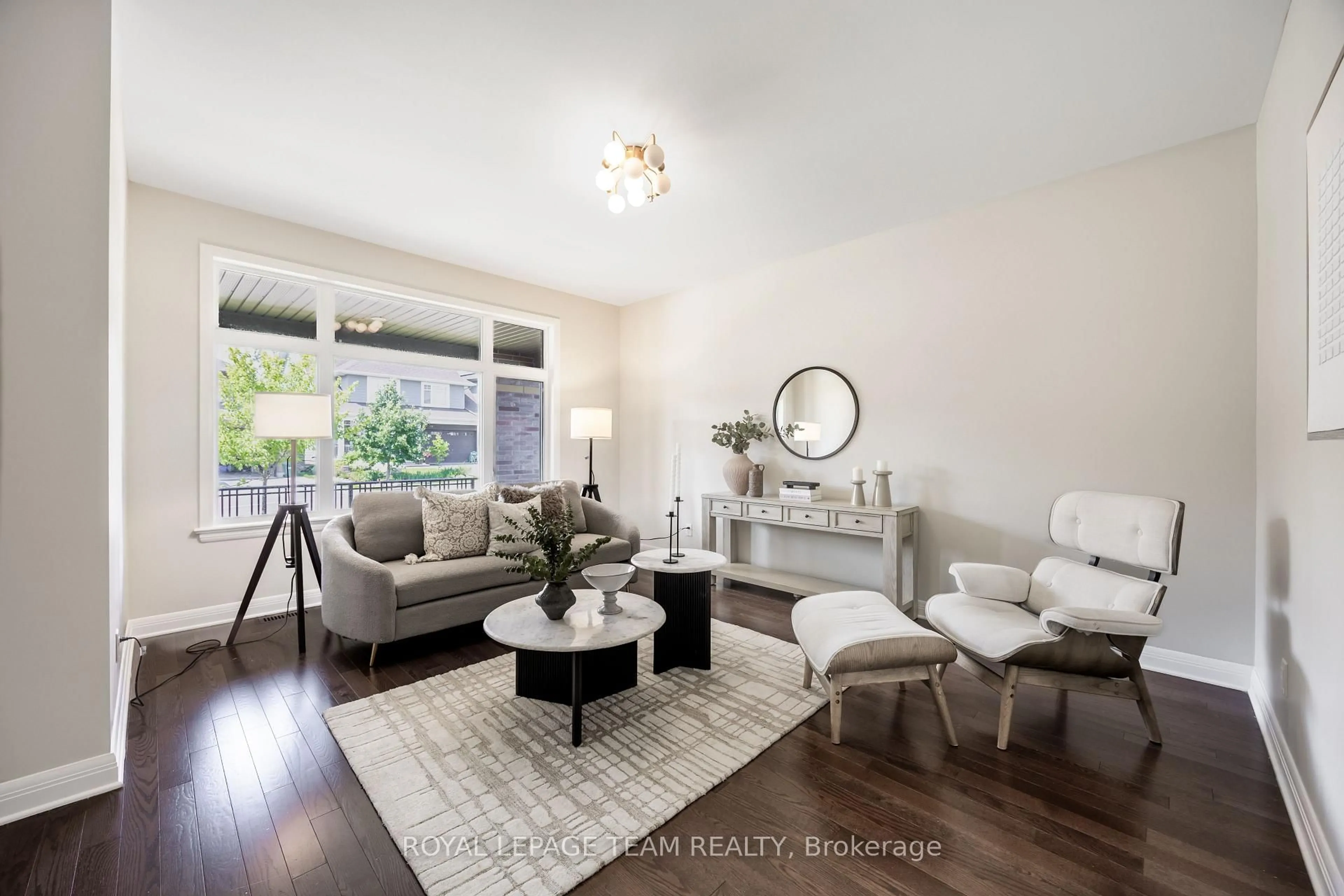 Living room with furniture, wood/laminate floor for 131 Escarpment Cres, Ottawa Ontario K2T 0L8