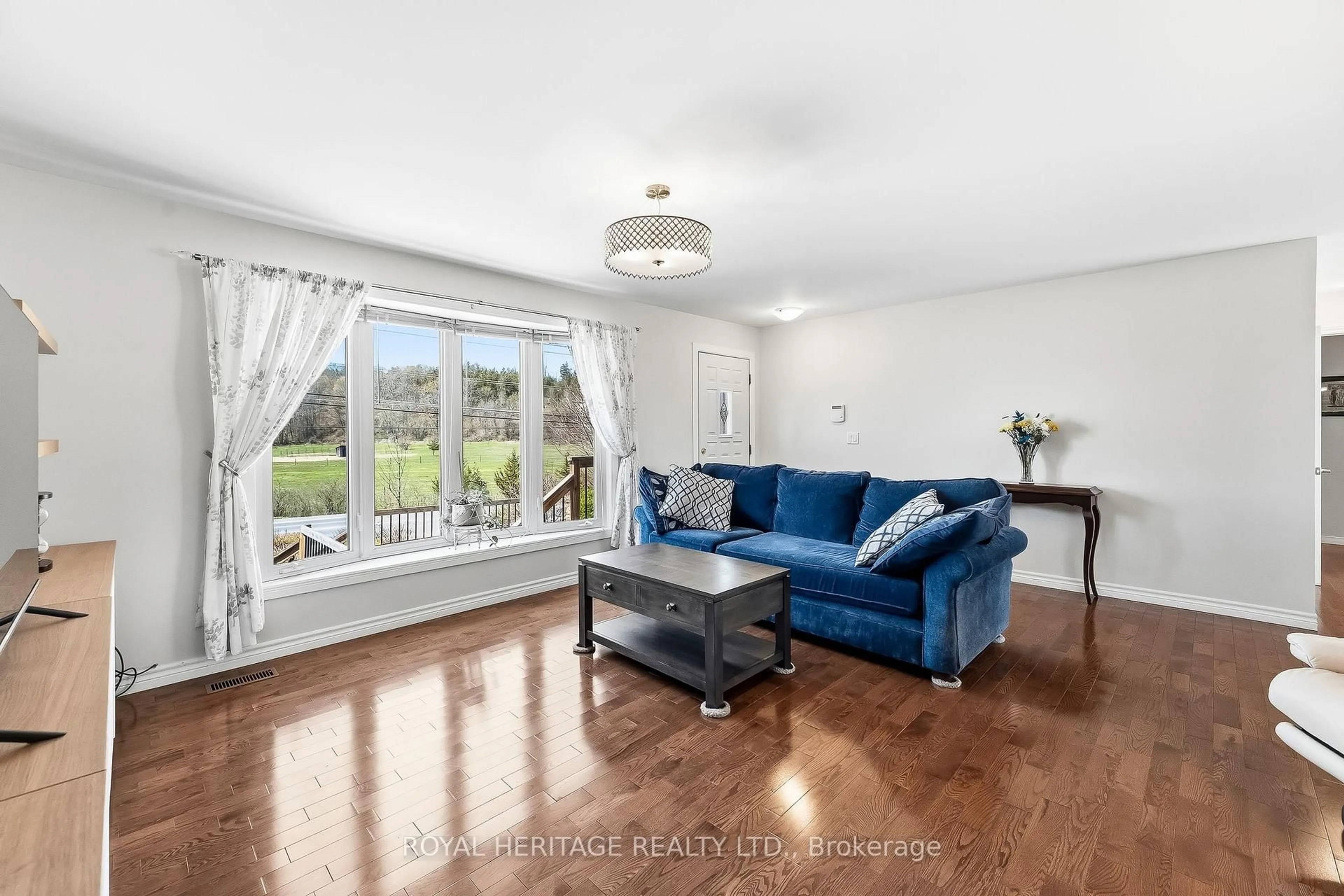 Living room with furniture, wood/laminate floor for 2434 Wallbridge Loyalist Rd, Quinte West Ontario K0K 2B0