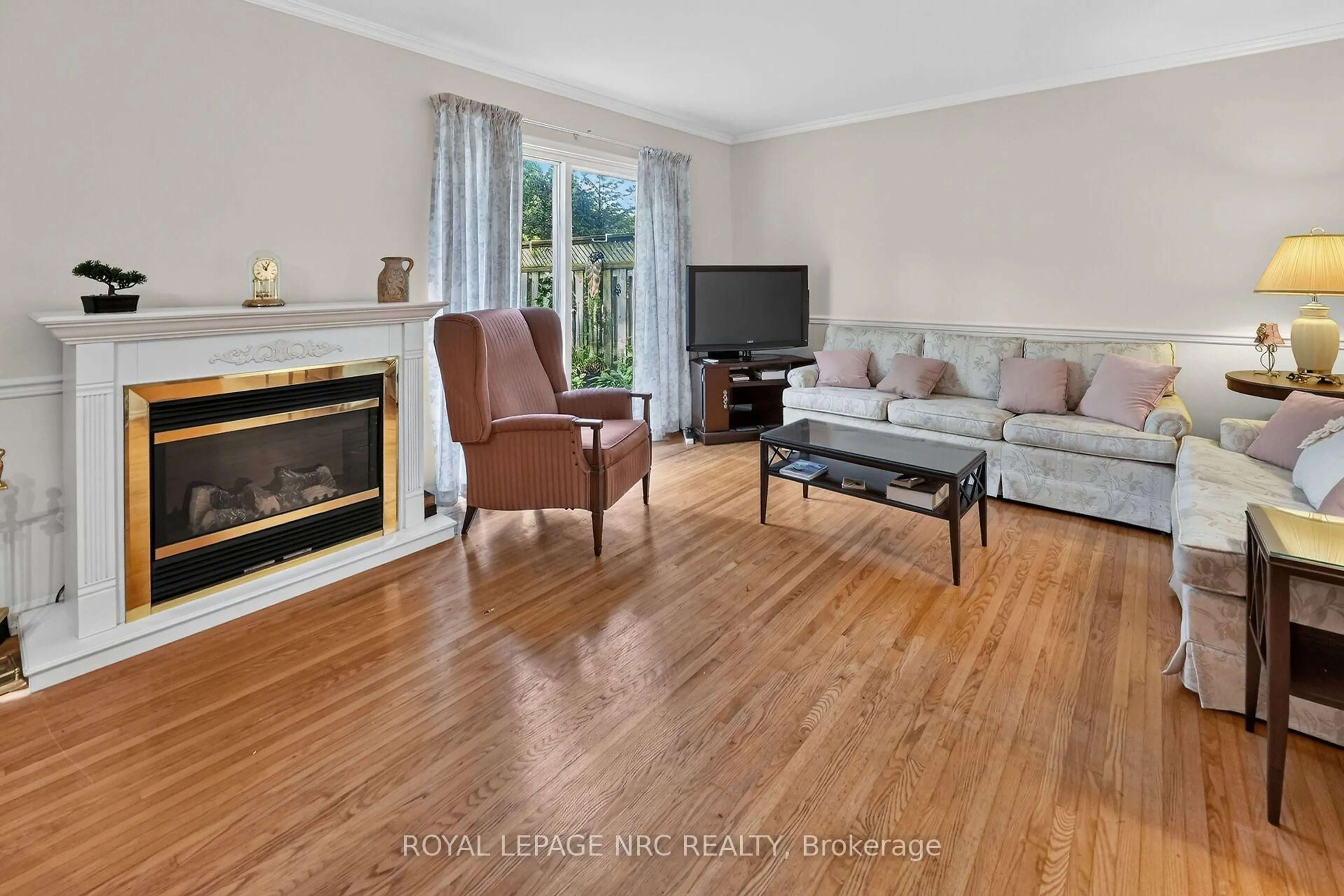 Living room with furniture, wood/laminate floor for 6453 Colborne St #62, Niagara Falls Ontario L2J 1E7