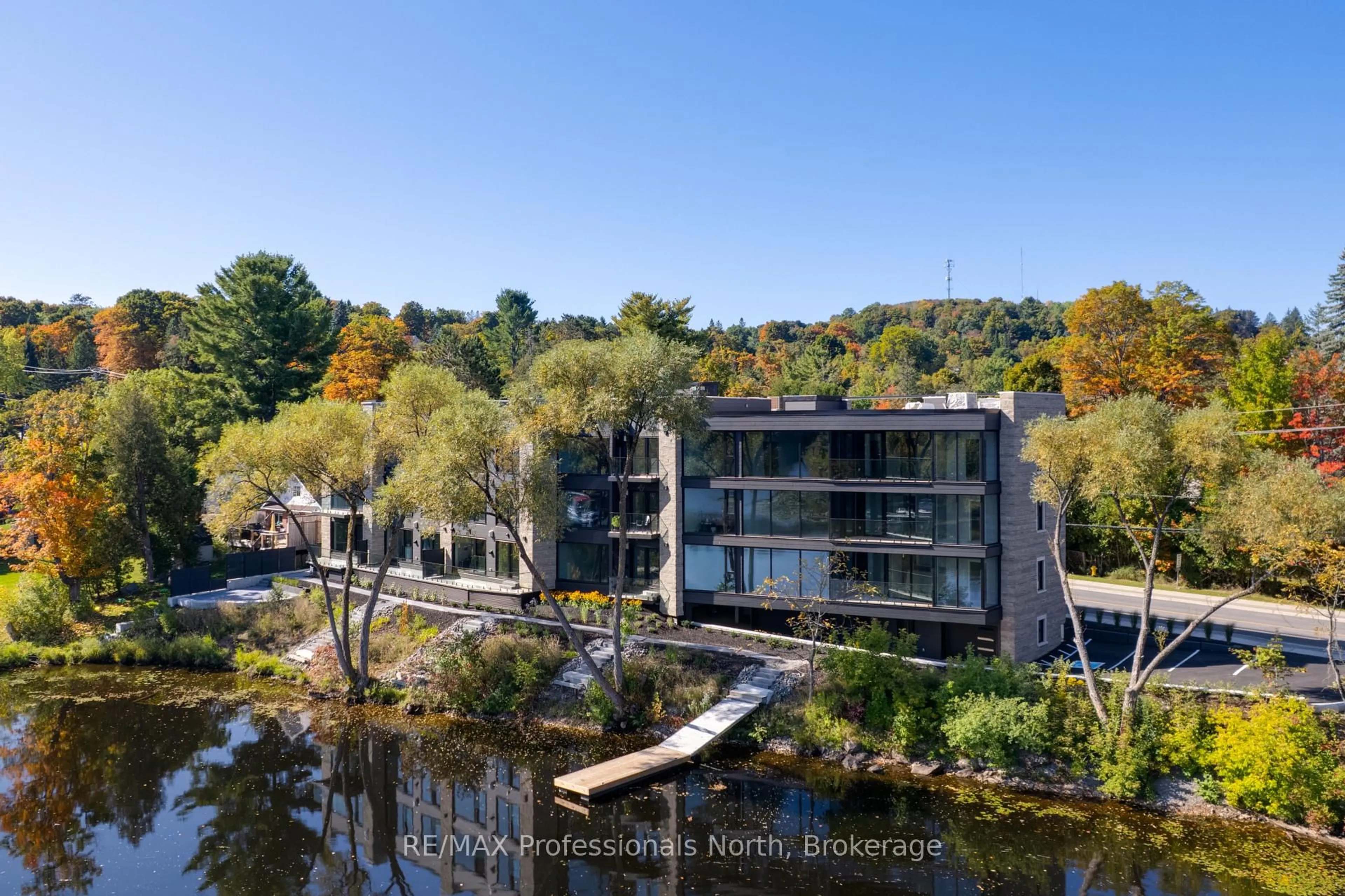 A pic from outside/outdoor area/front of a property/back of a property/a pic from drone, water/lake/river/ocean view for 32 Brunel Rd #203, Huntsville Ontario P1H 1P5