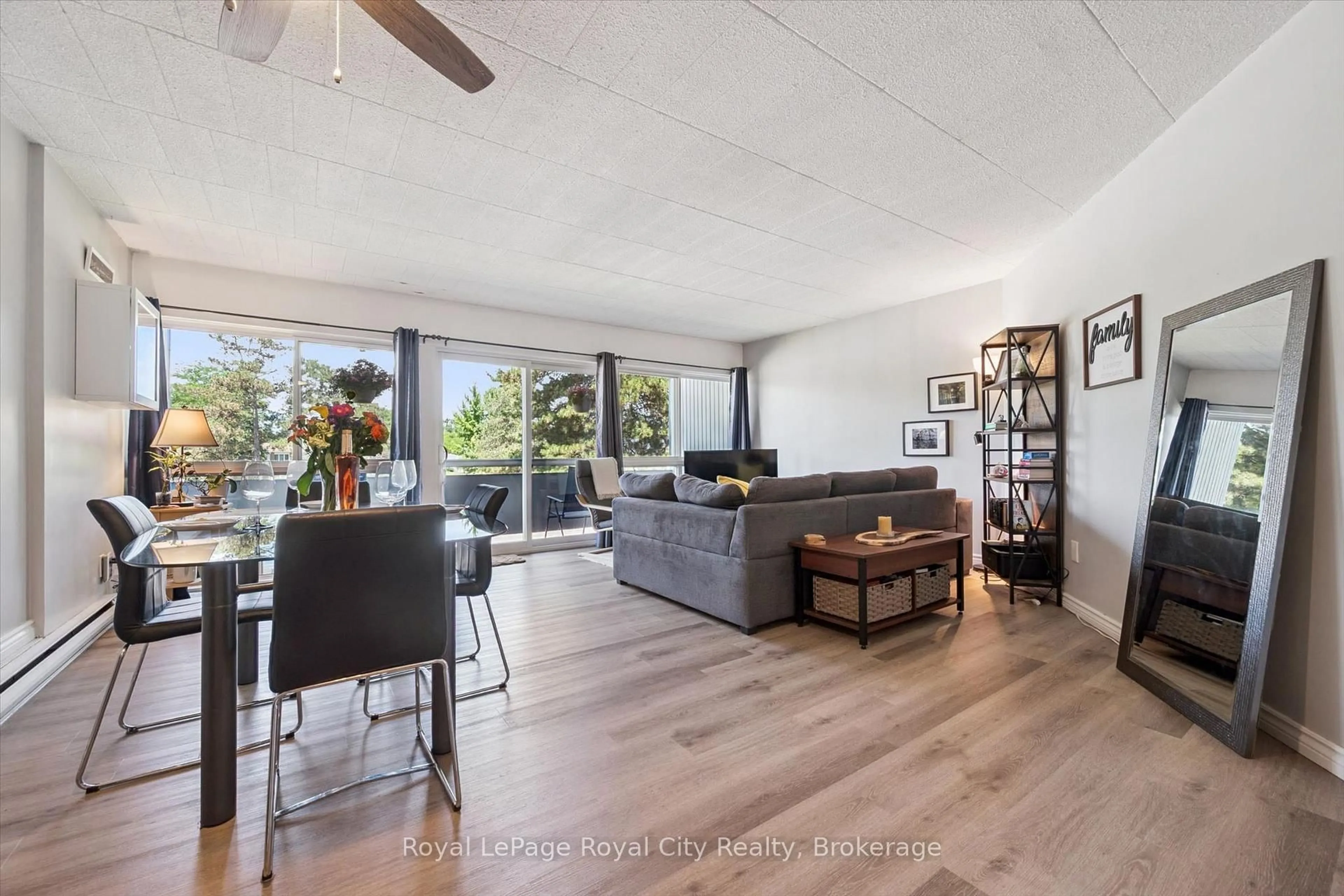 Living room with furniture, wood/laminate floor for 105 Conroy Cres #410, Guelph Ontario N1G 2V5