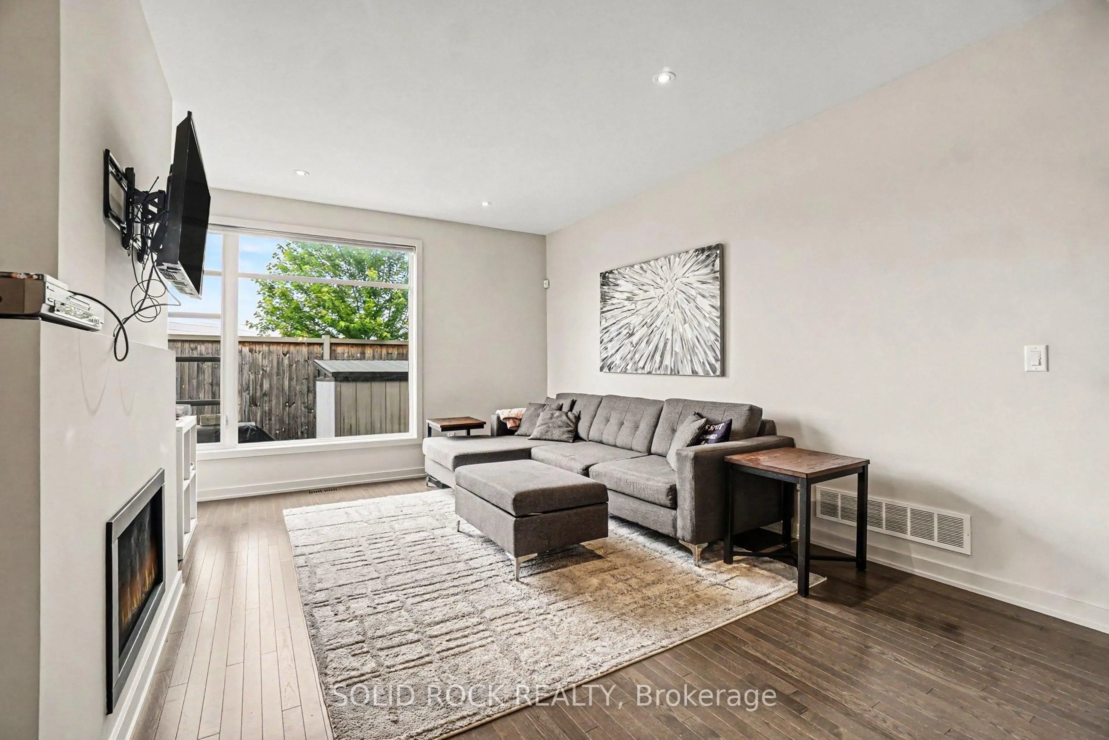 Living room with furniture, wood/laminate floor for 114 Larimar Circ, Ottawa Ontario K1X 0B7