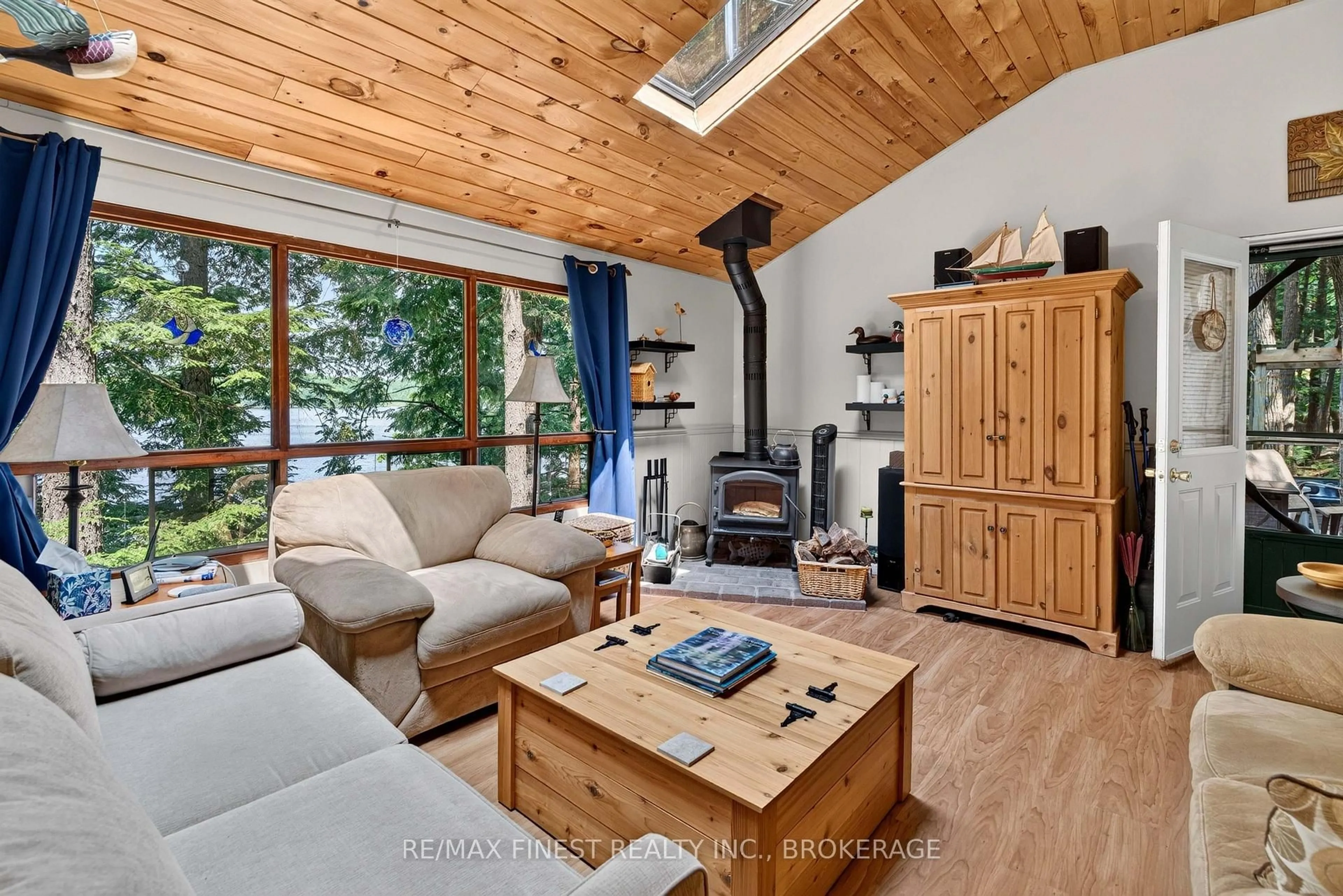 Living room with furniture, wood/laminate floor for 701 Davern Lane, Maberly Ontario K0H 2B0