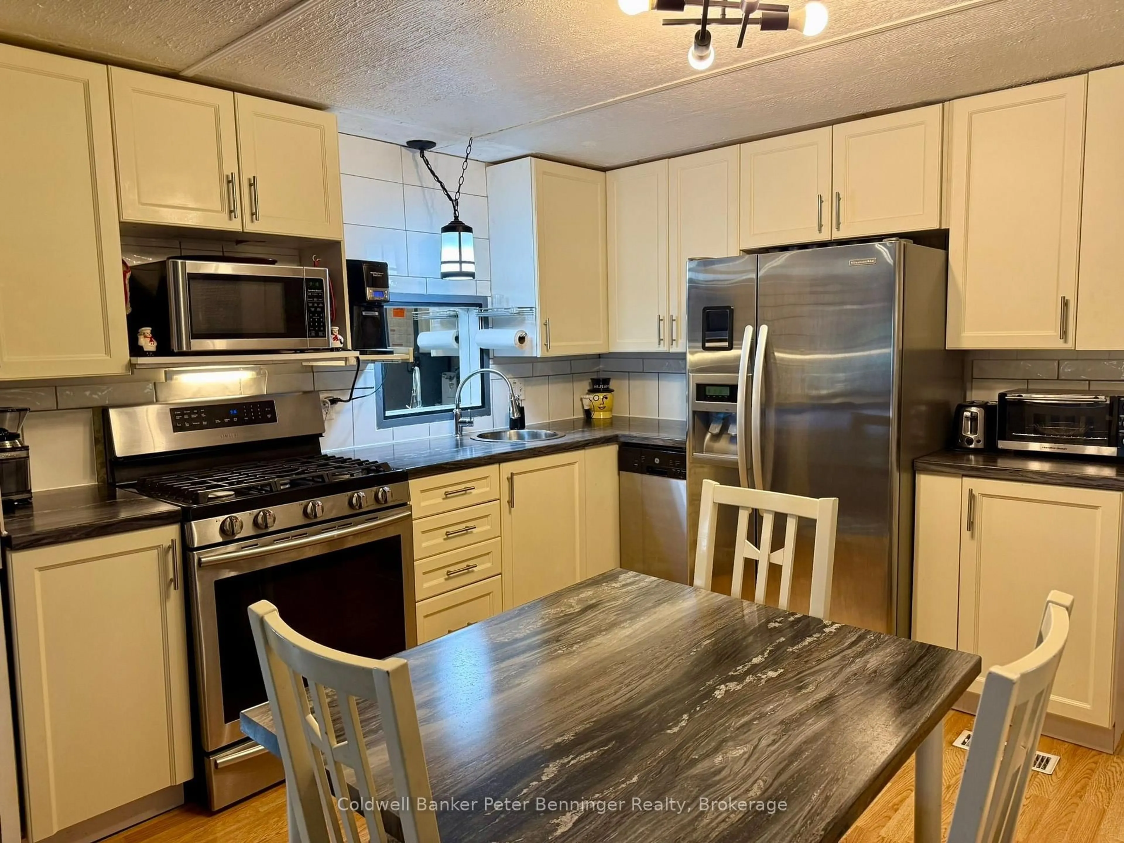 Open concept kitchen, wood/laminate floor for 23 Bluejay Crt, Brockton Ontario N0G 2V0