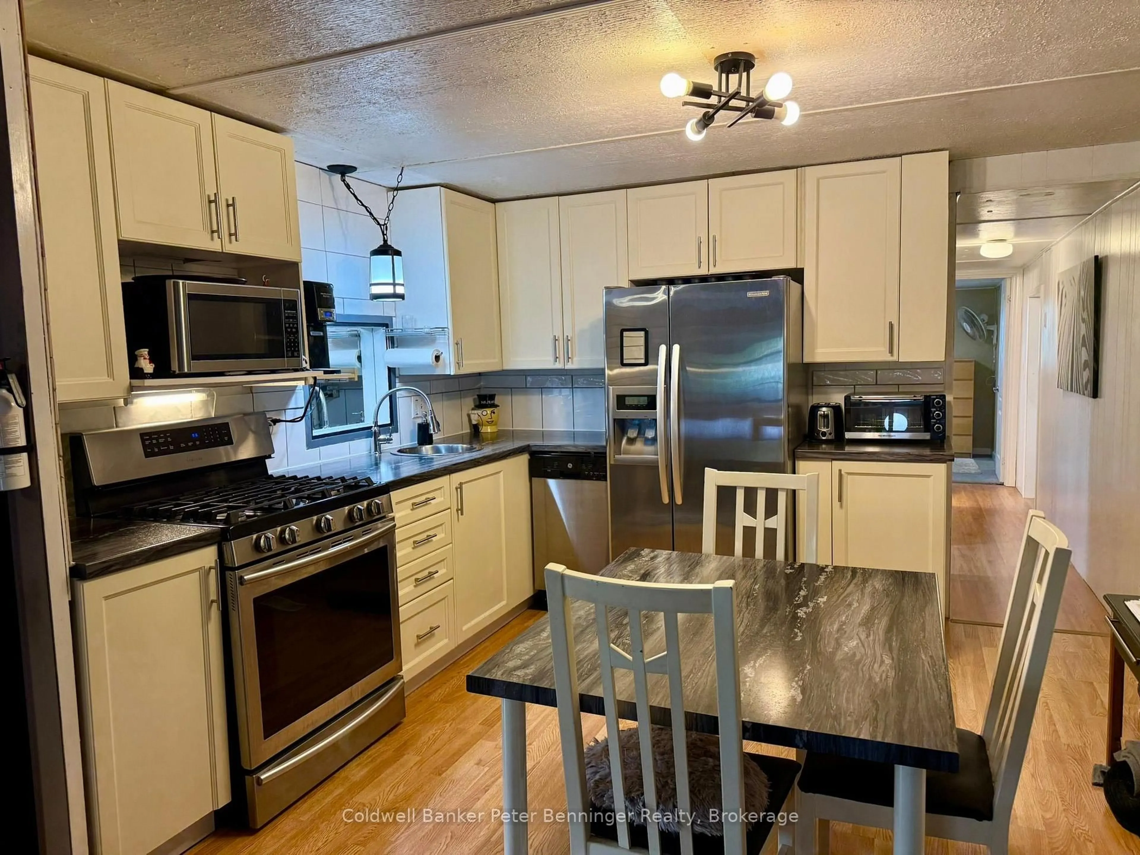 Open concept kitchen, wood/laminate floor for 23 Bluejay Crt, Brockton Ontario N0G 2V0