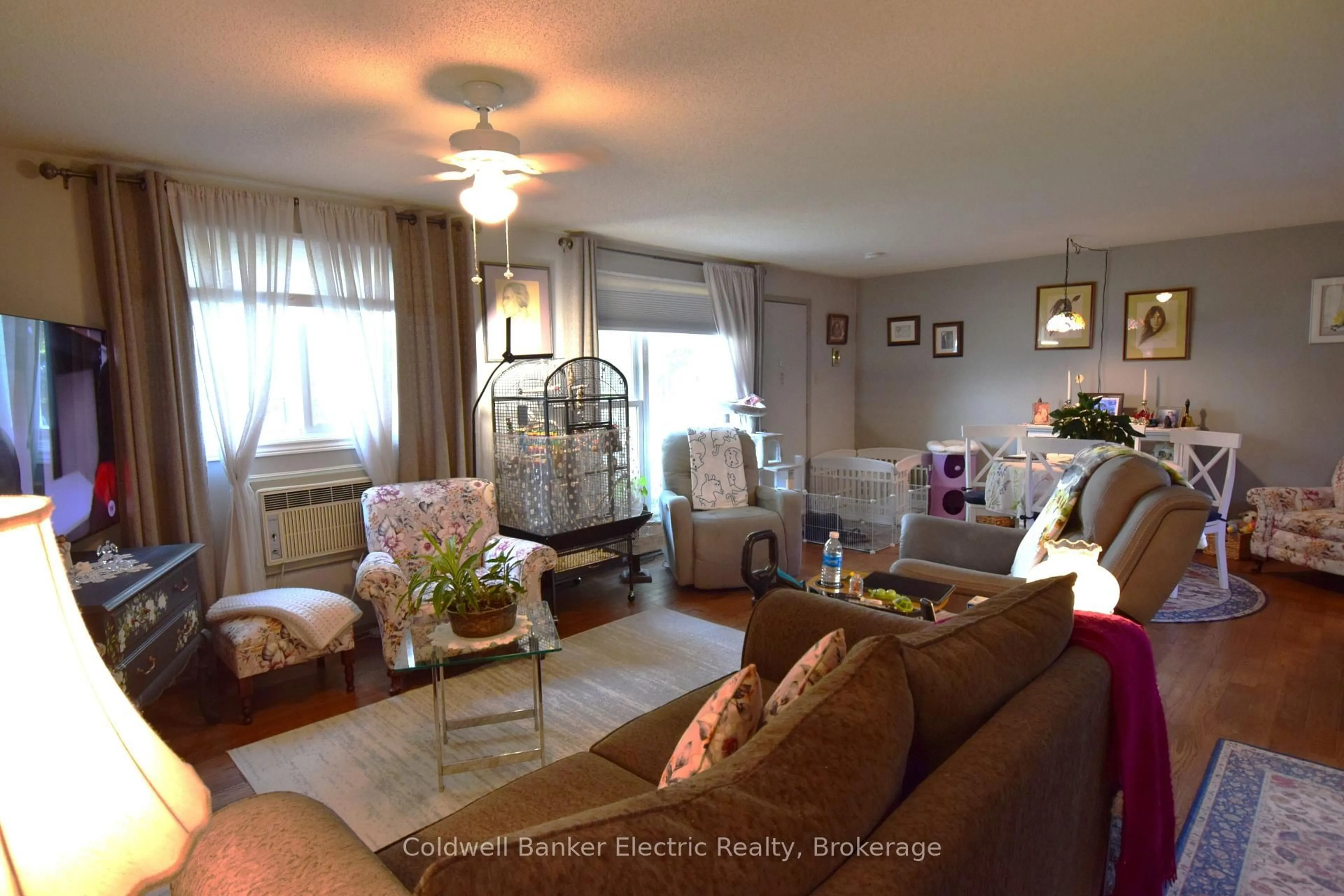 Living room with furniture, wood/laminate floor for 2418 Mountland Dr #104, Peterborough Ontario K9K 2E2