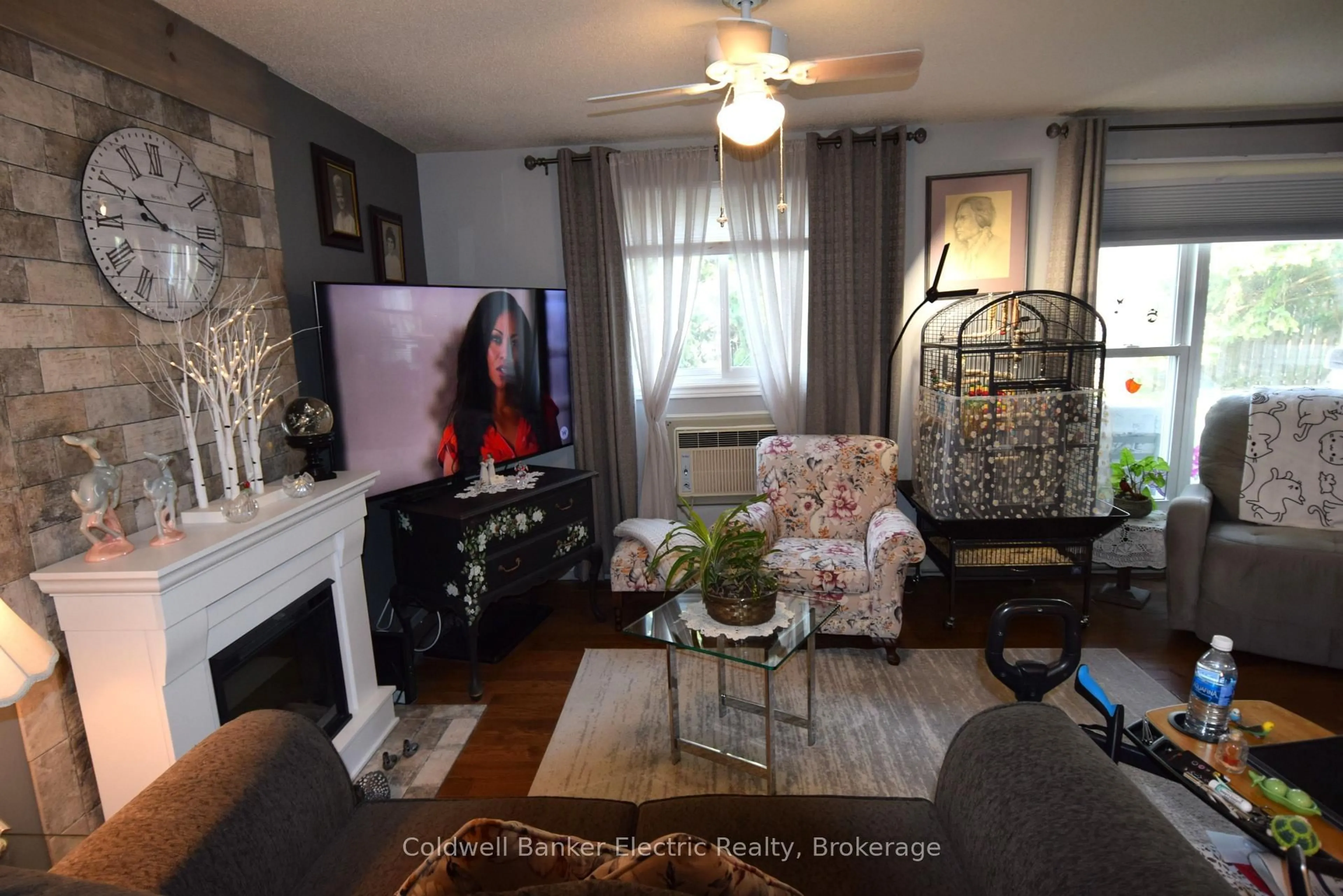 Living room with furniture, wood/laminate floor for 2418 Mountland Dr #104, Peterborough Ontario K9K 2E2