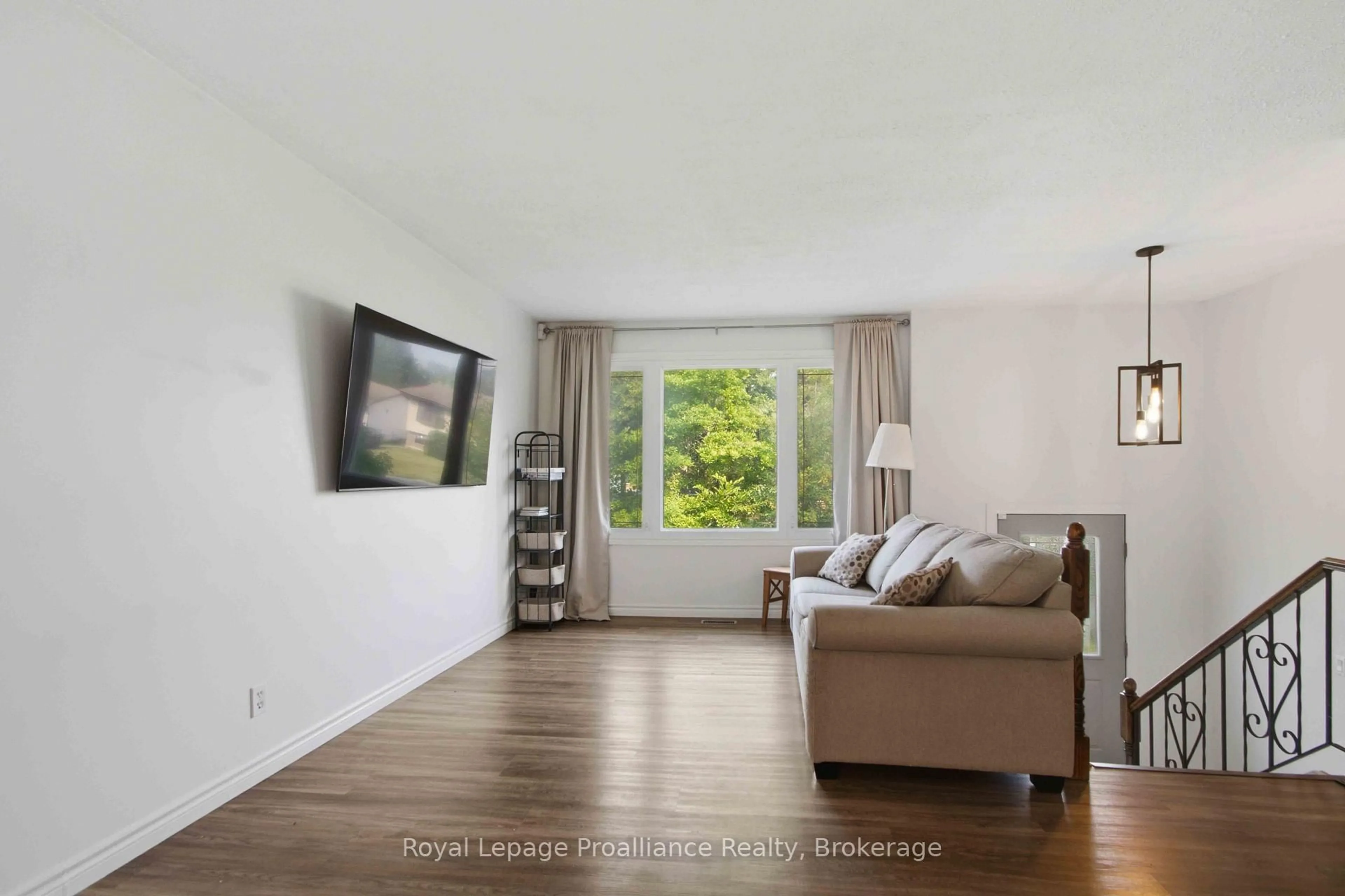 Living room with furniture, wood/laminate floor for 25 Radeski St, Quinte West Ontario K8V 6B6