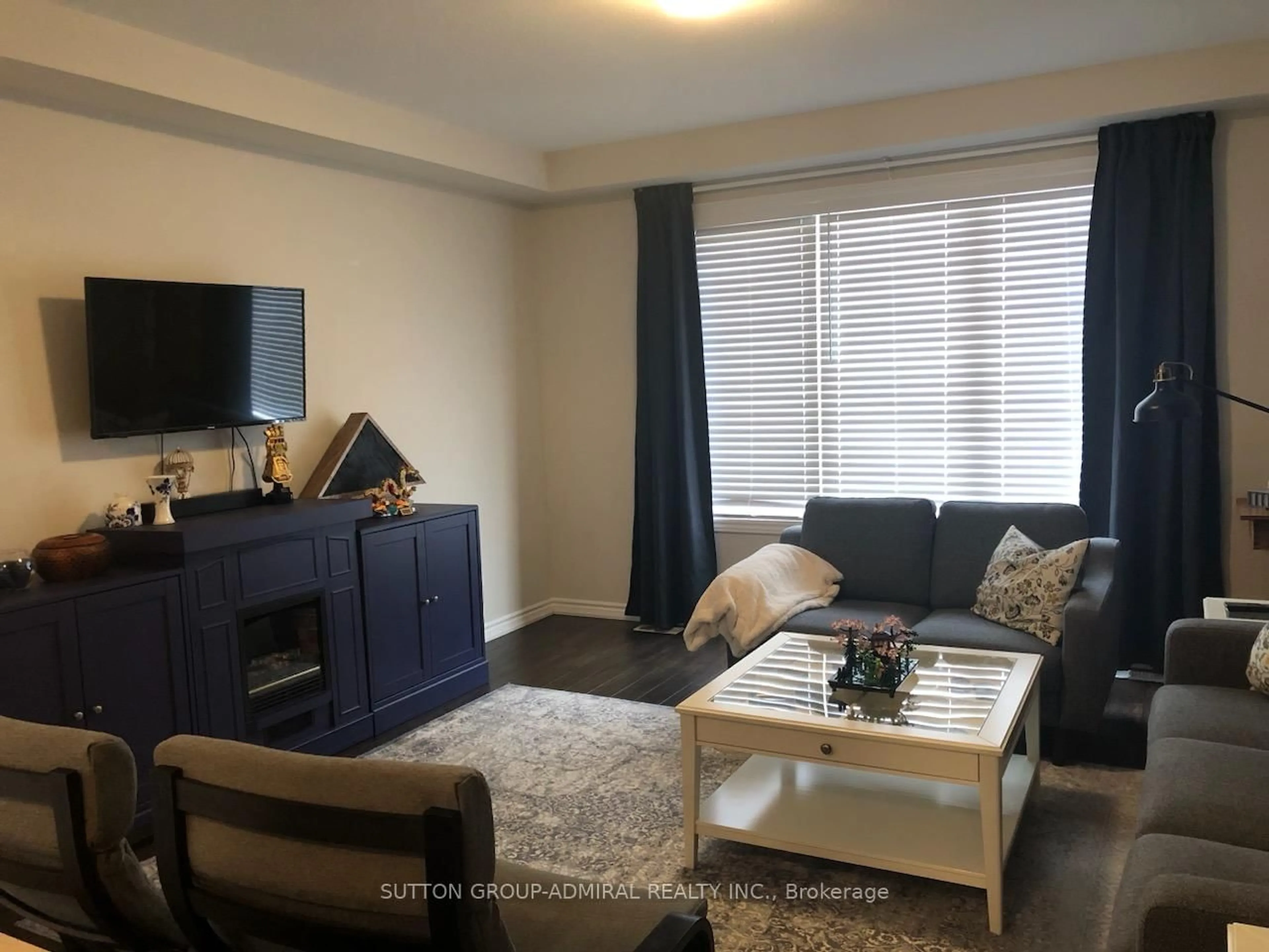 Living room with furniture, wood/laminate floor for 706 Brittanic Rd, Ottawa Ontario K2V 0N8