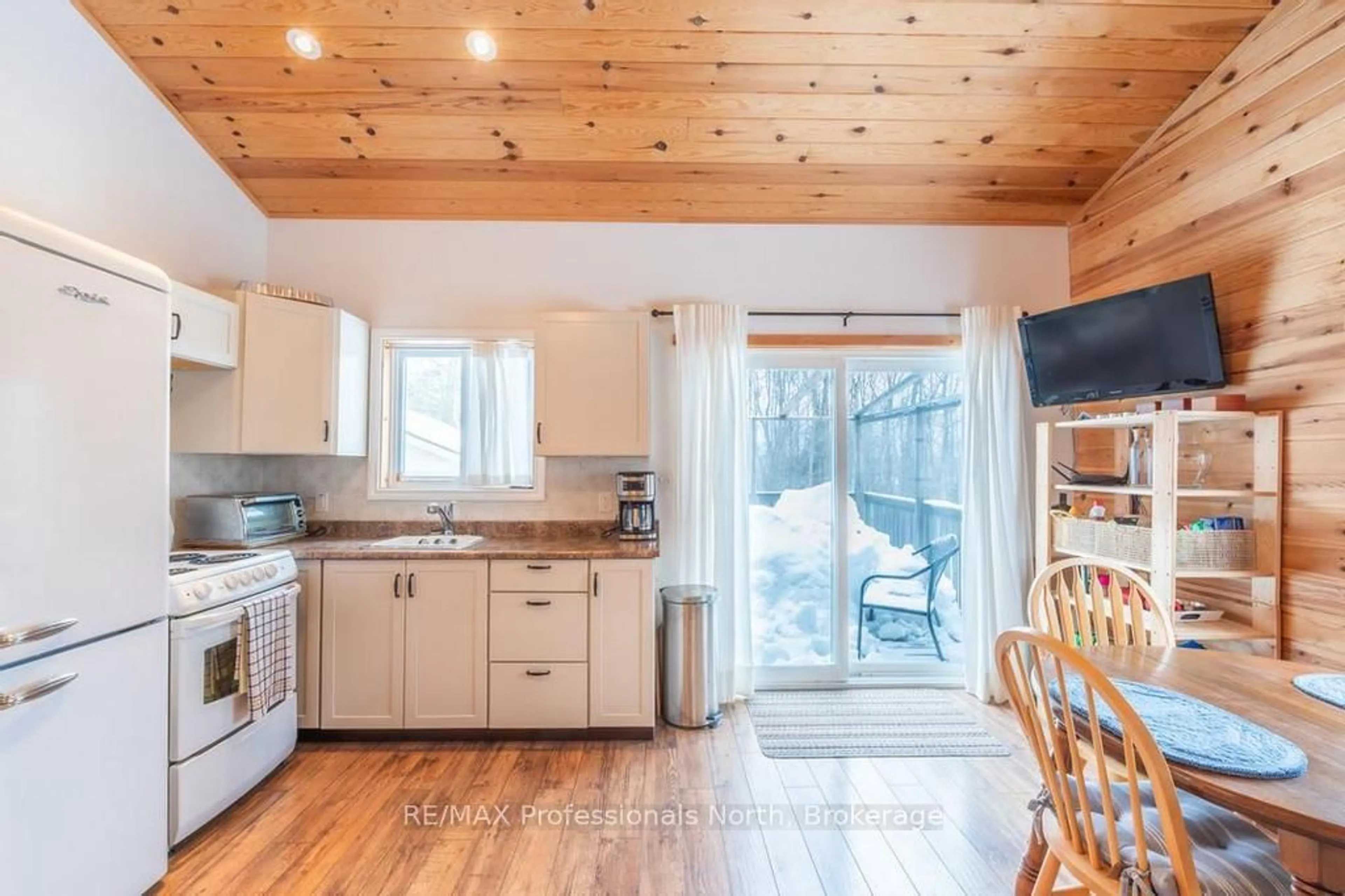 Open concept kitchen, wood/laminate floor for 1145 Chelsea Lane, Algonquin Highlands Ontario K0M 1J1