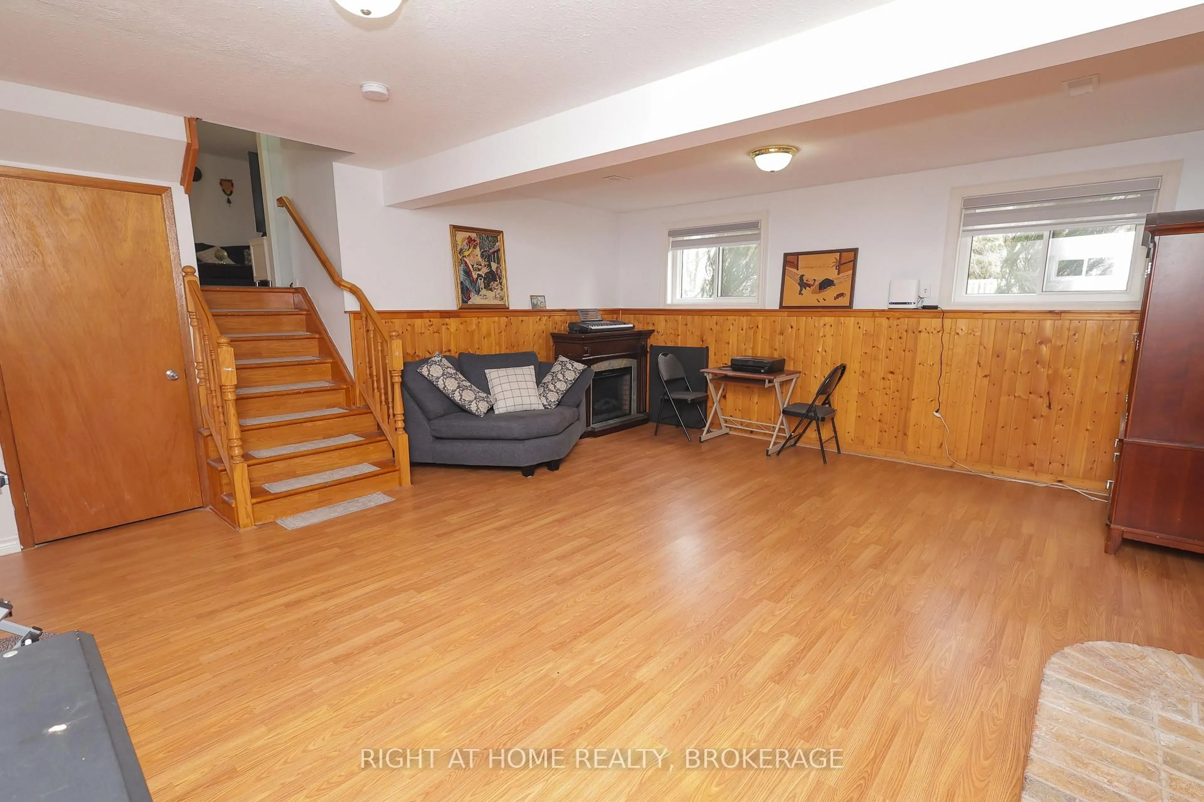 Living room with furniture, wood/laminate floor for 7698 Mulhern St, Niagara Falls Ontario L2H 1B5
