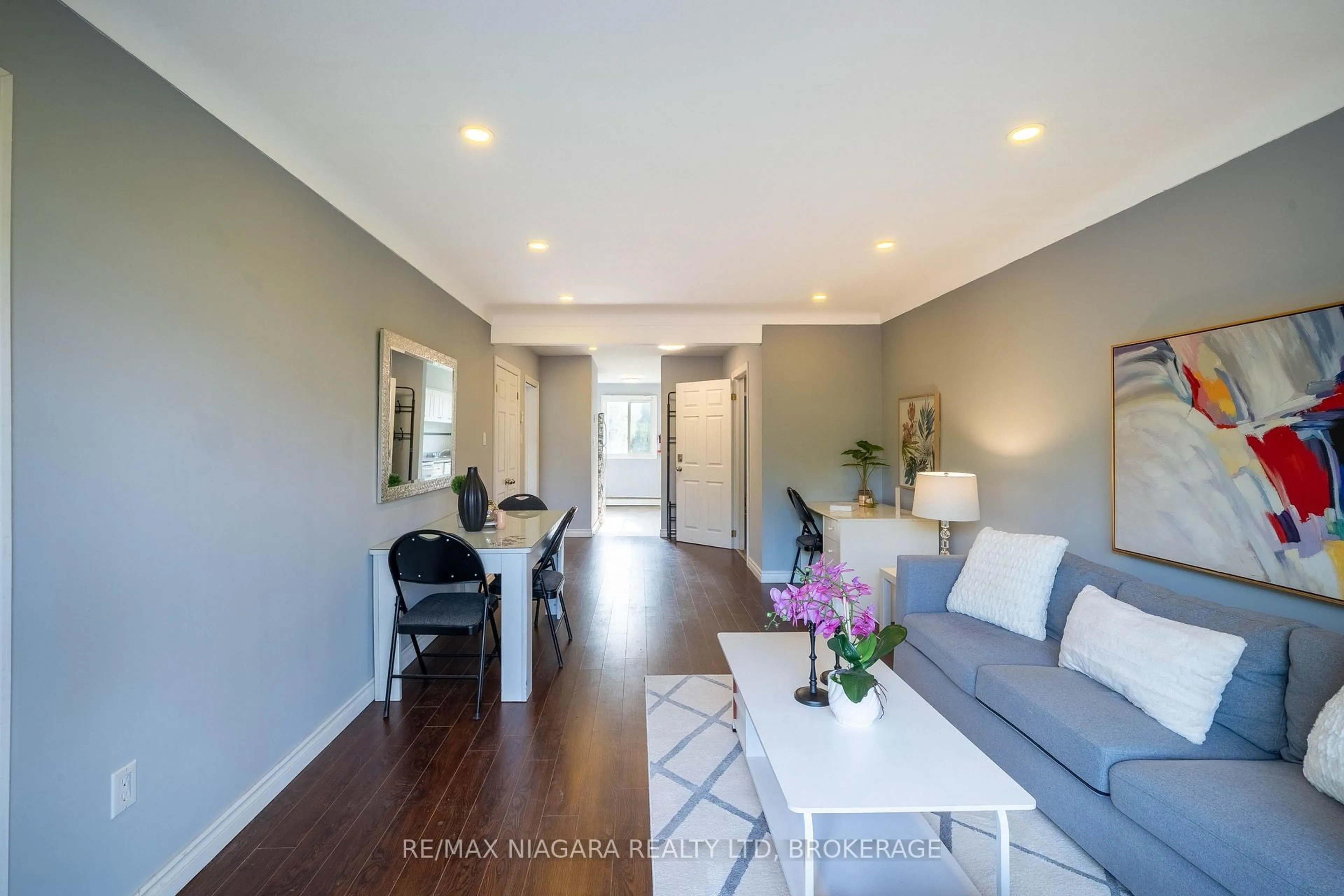 Living room with furniture, wood/laminate floor for 293-295 Glenridge Ave, St. Catharines Ontario L2T 3K5