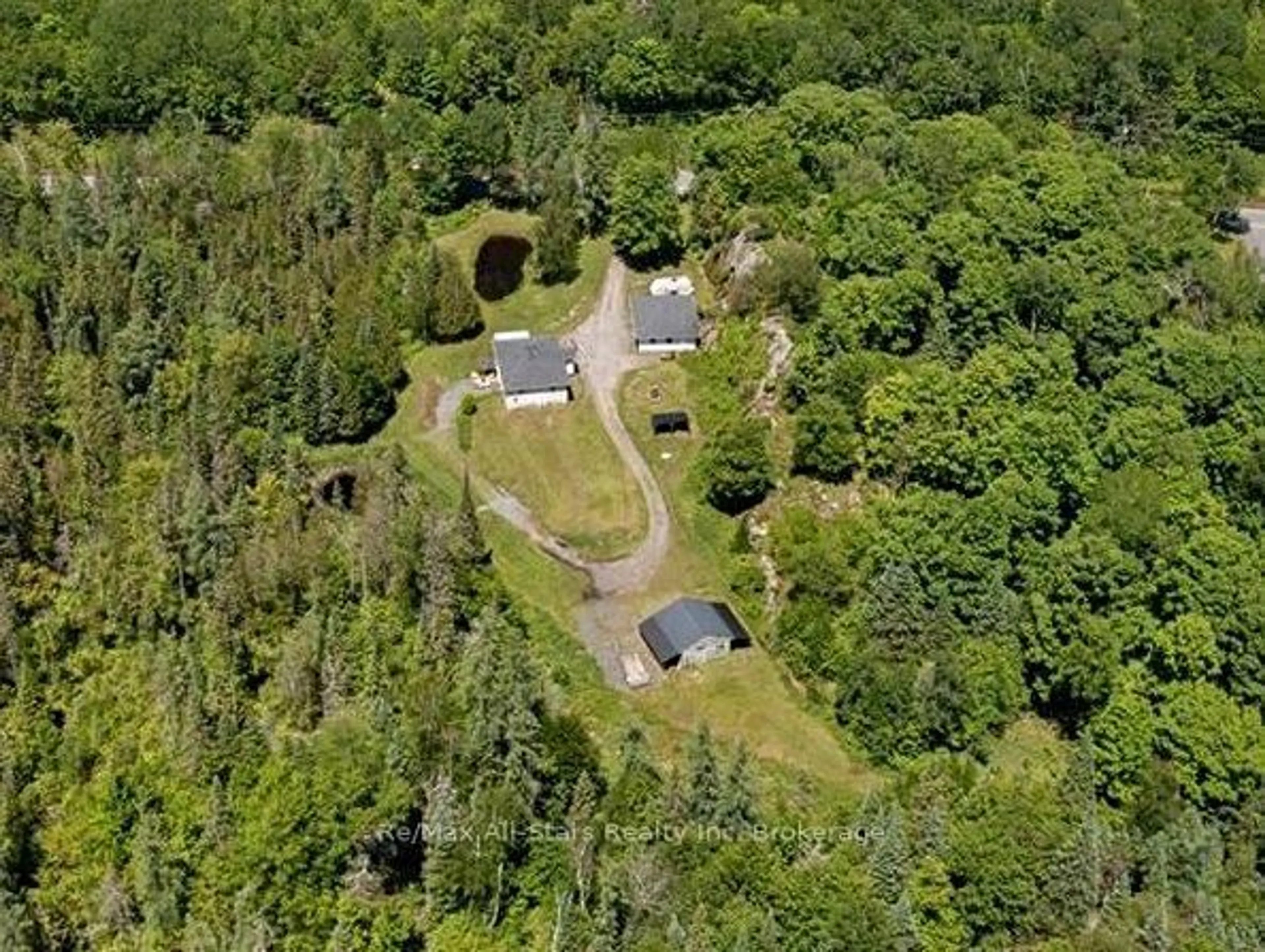 A pic from outside/outdoor area/front of a property/back of a property/a pic from drone, forest/trees view for 410 Etwell Rd, Huntsville Ontario P1H 2J2