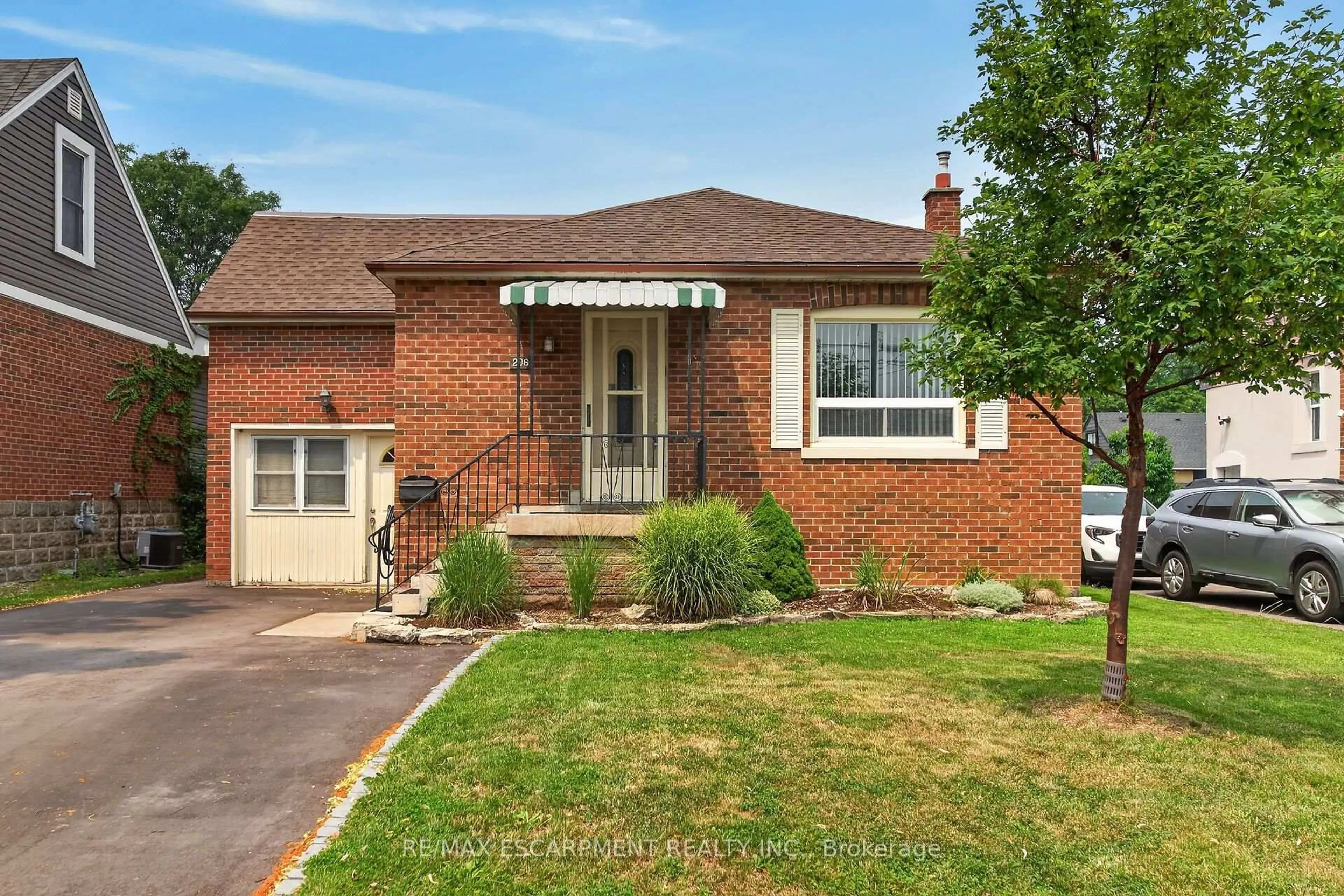 Home with brick exterior material, street for 206 EAST 13TH St, Hamilton Ontario L9A 3Z7