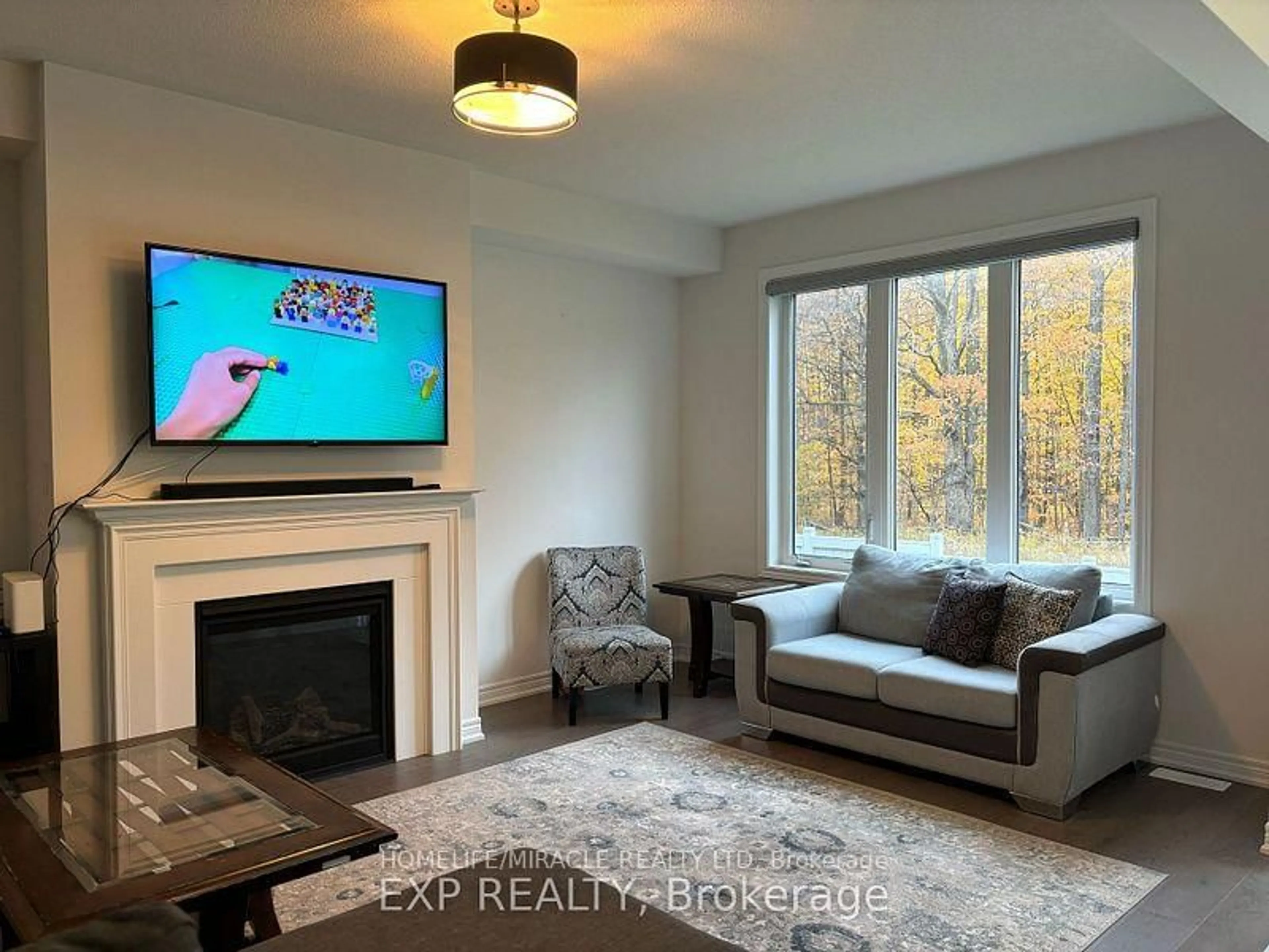 Living room with furniture, wood/laminate floor for 488 Black Cherry Cres, Shelburne Ontario L9V 3Y7