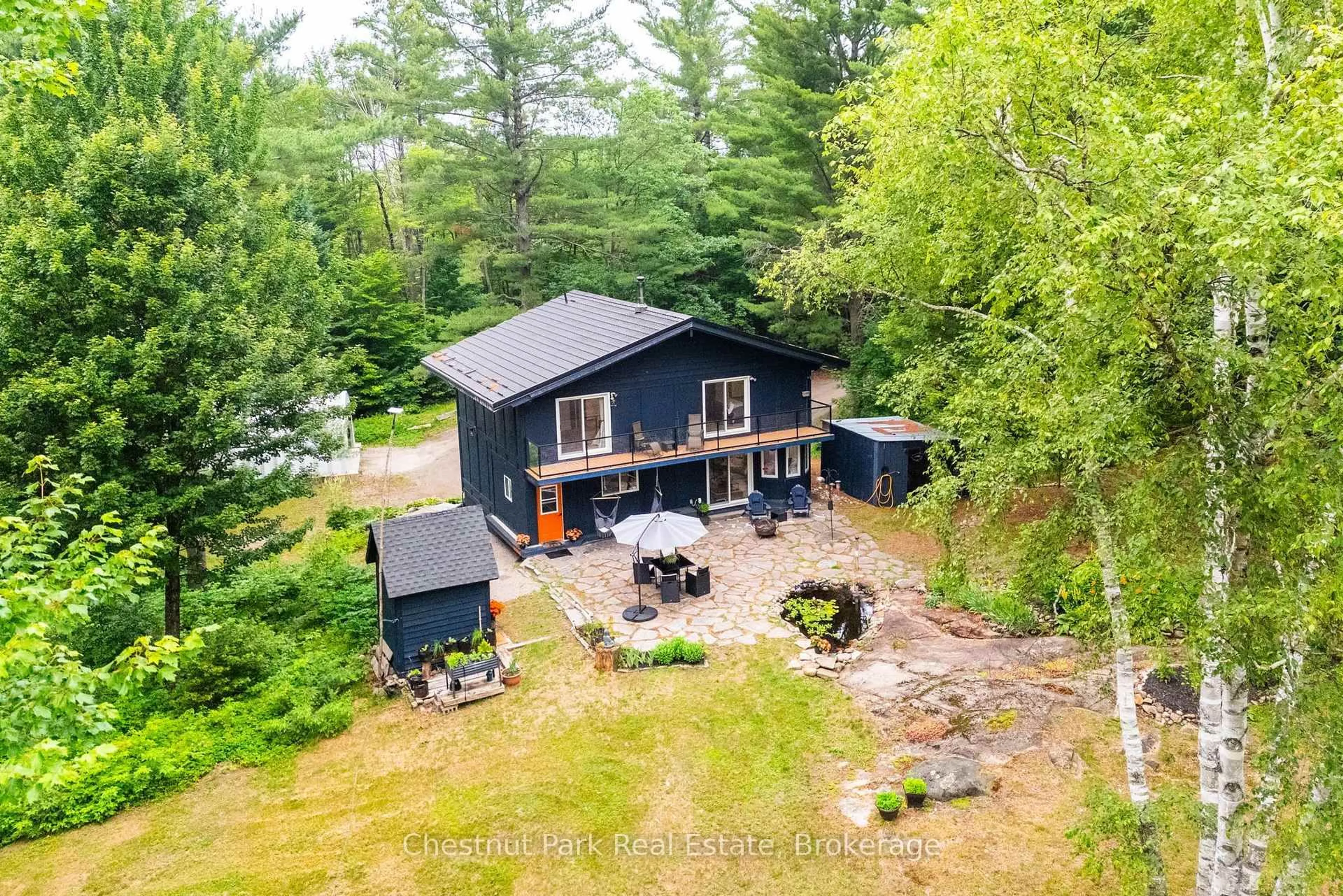 A pic from outside/outdoor area/front of a property/back of a property/a pic from drone, water/lake/river/ocean view for 647 Lynx Lake Rd, Huntsville Ontario P1H 2J3