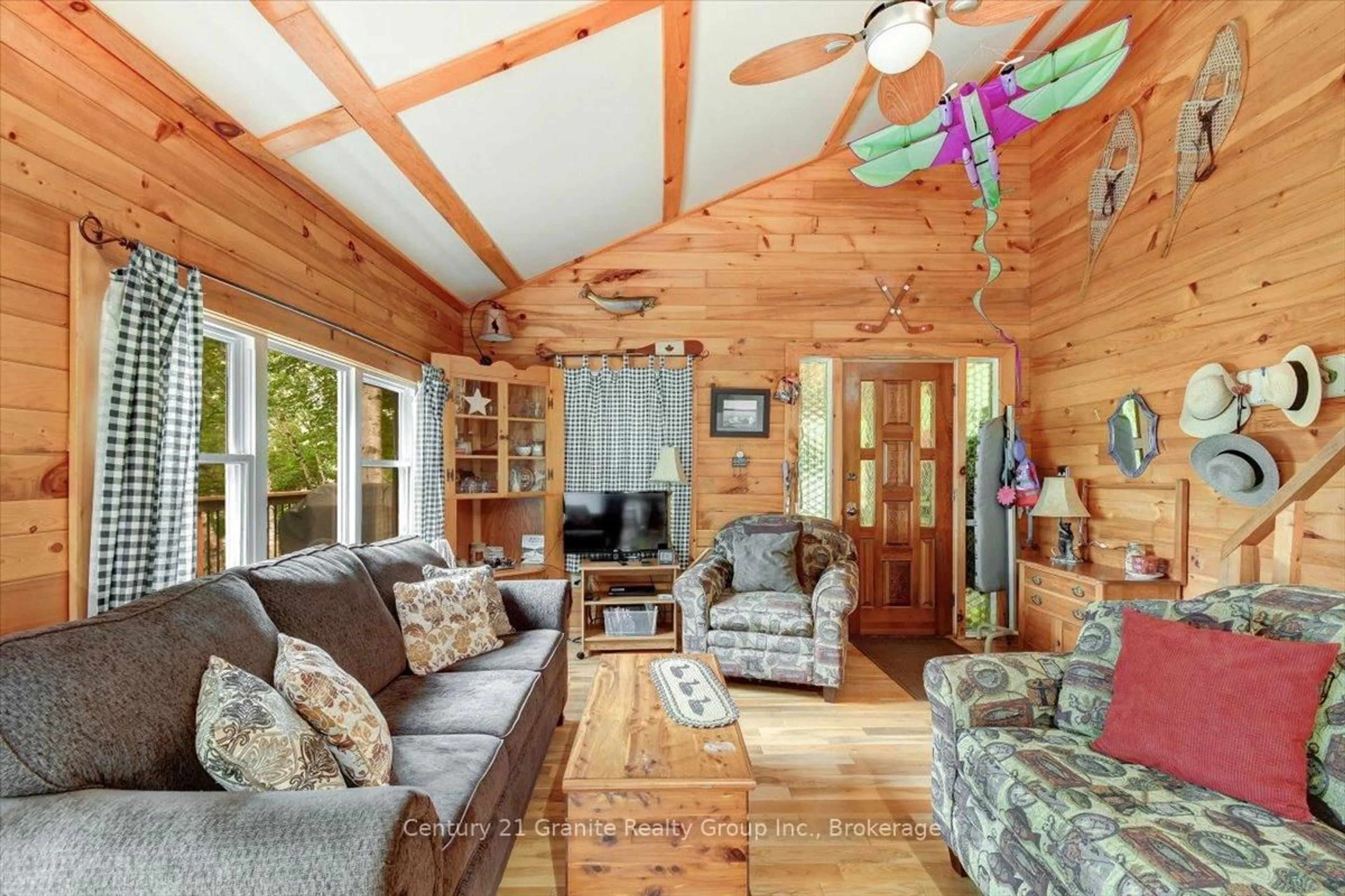 Living room with furniture, wood/laminate floor for 91 Ups & Downs Lane, South Algonquin Ontario K0L 2K0