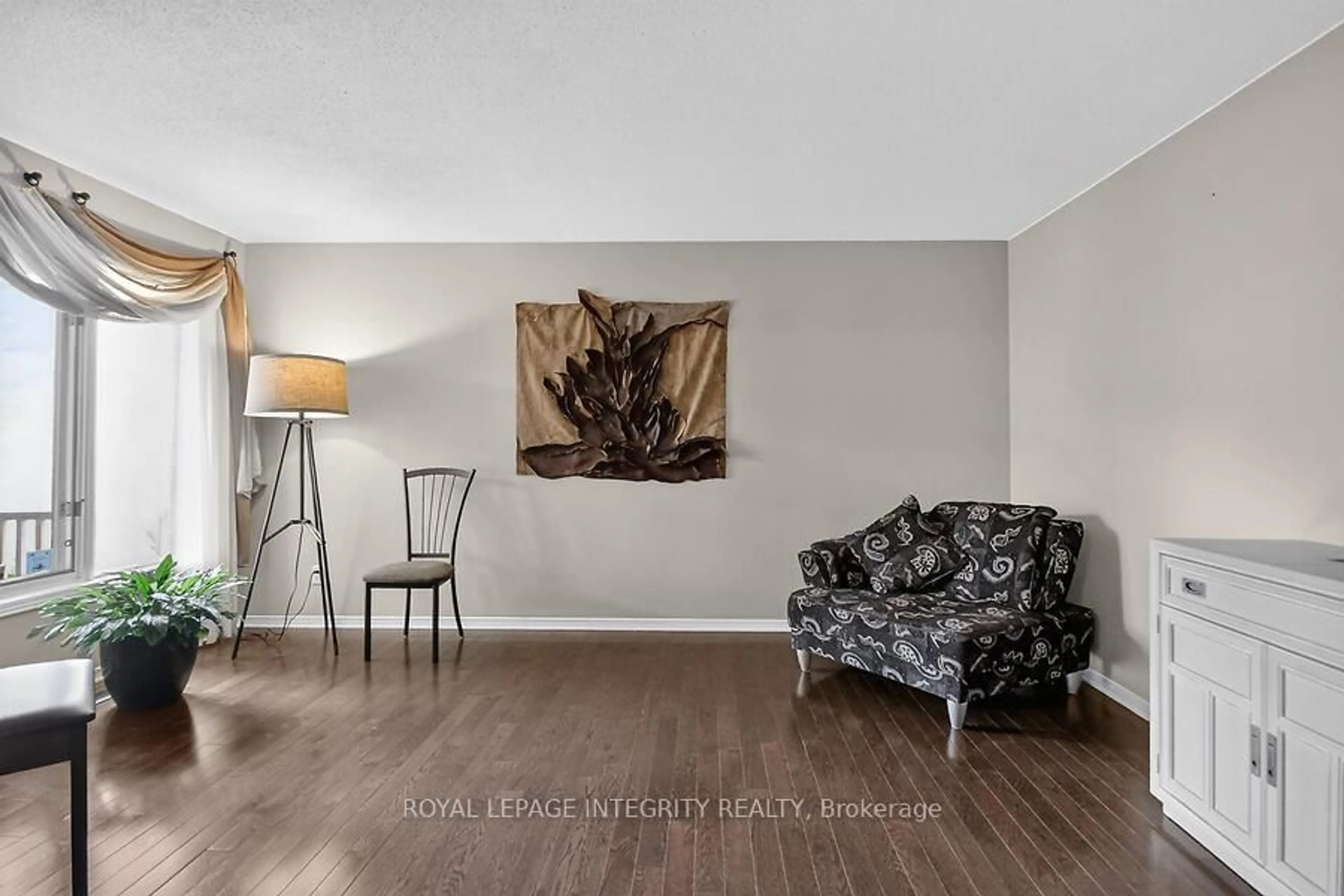 Living room with furniture, wood/laminate floor for 76 Saddlehorn Cres, Ottawa Ontario K2M 2B1