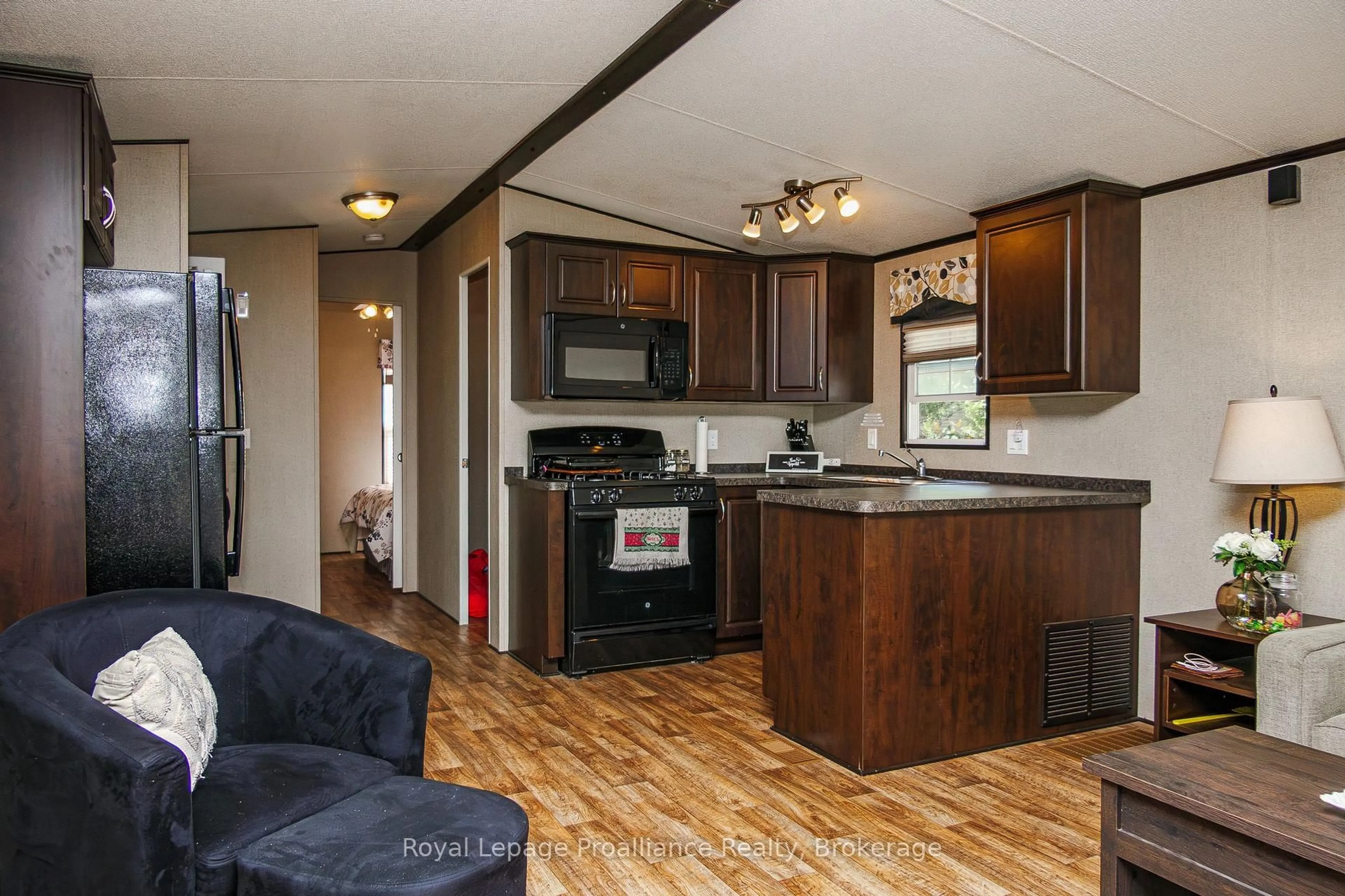 Open concept kitchen, wood/laminate floor for 486 Cty Rd 18 - 5 Cove Bay Lane, Prince Edward County Ontario K0K 1P0