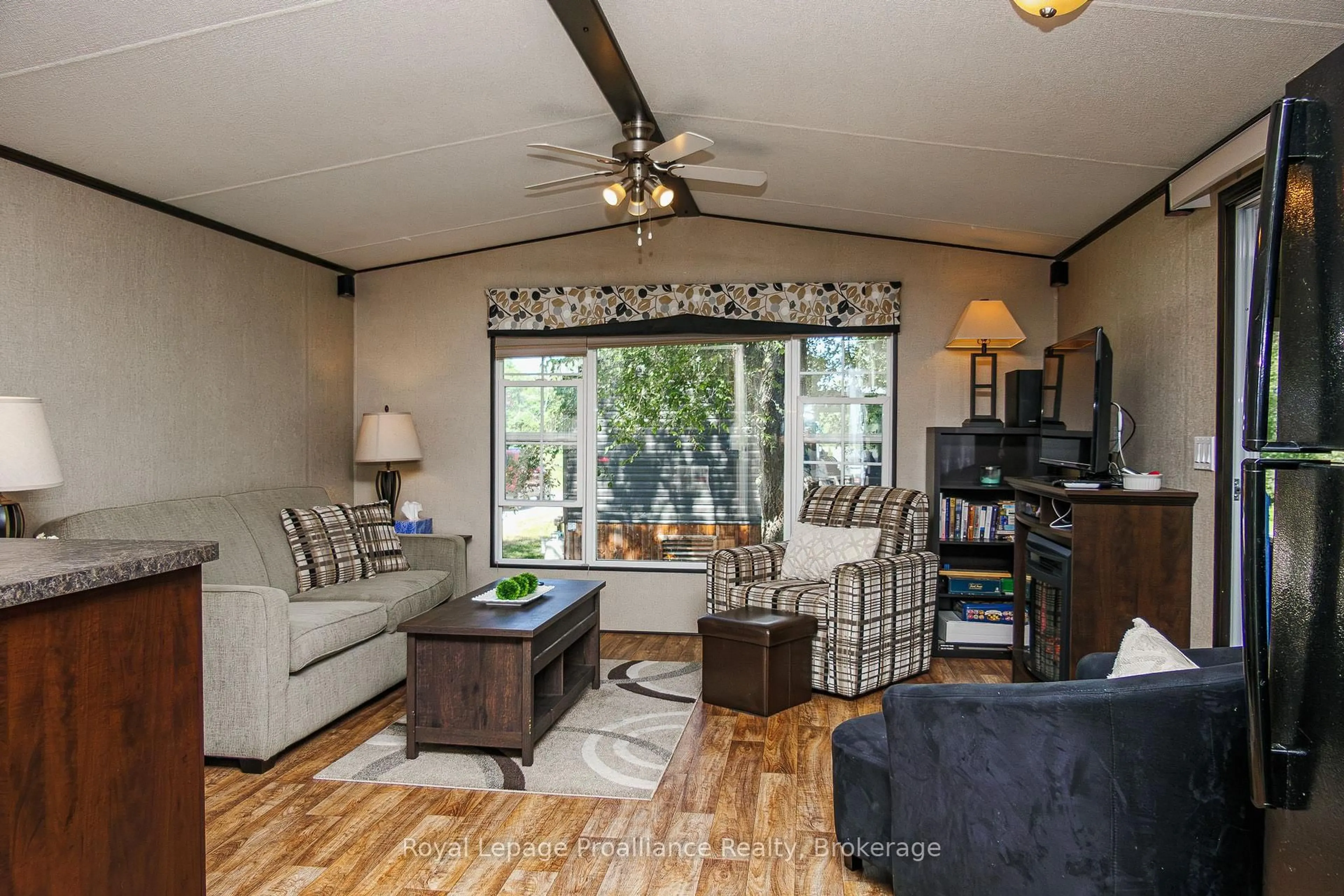 Living room with furniture, wood/laminate floor for 486 Cty Rd 18 - 5 Cove Bay Lane, Prince Edward County Ontario K0K 1P0