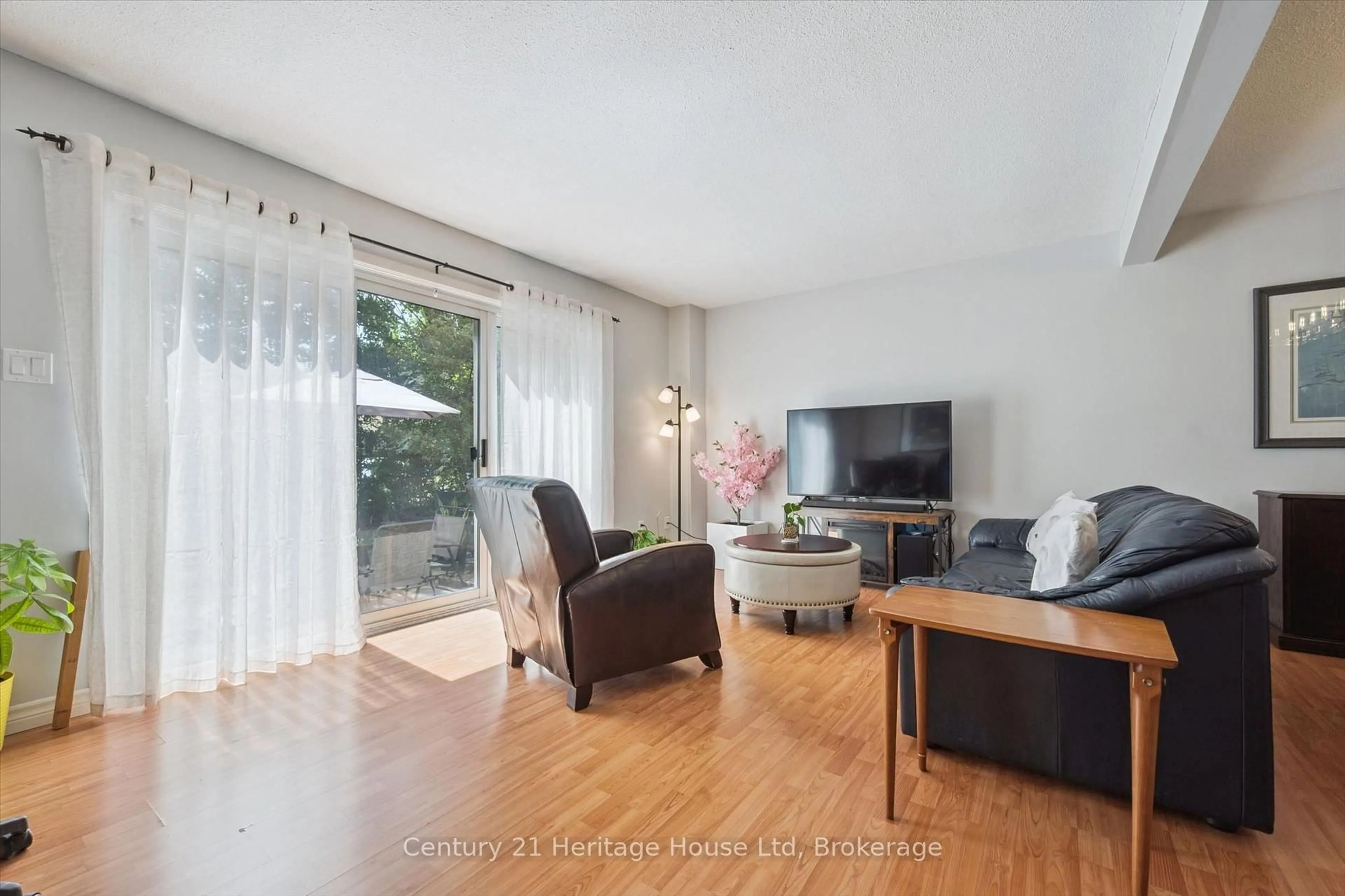 Living room with furniture, wood/laminate floor for 201 Silvercreek Pkwy #15, Guelph Ontario N1H 3T4