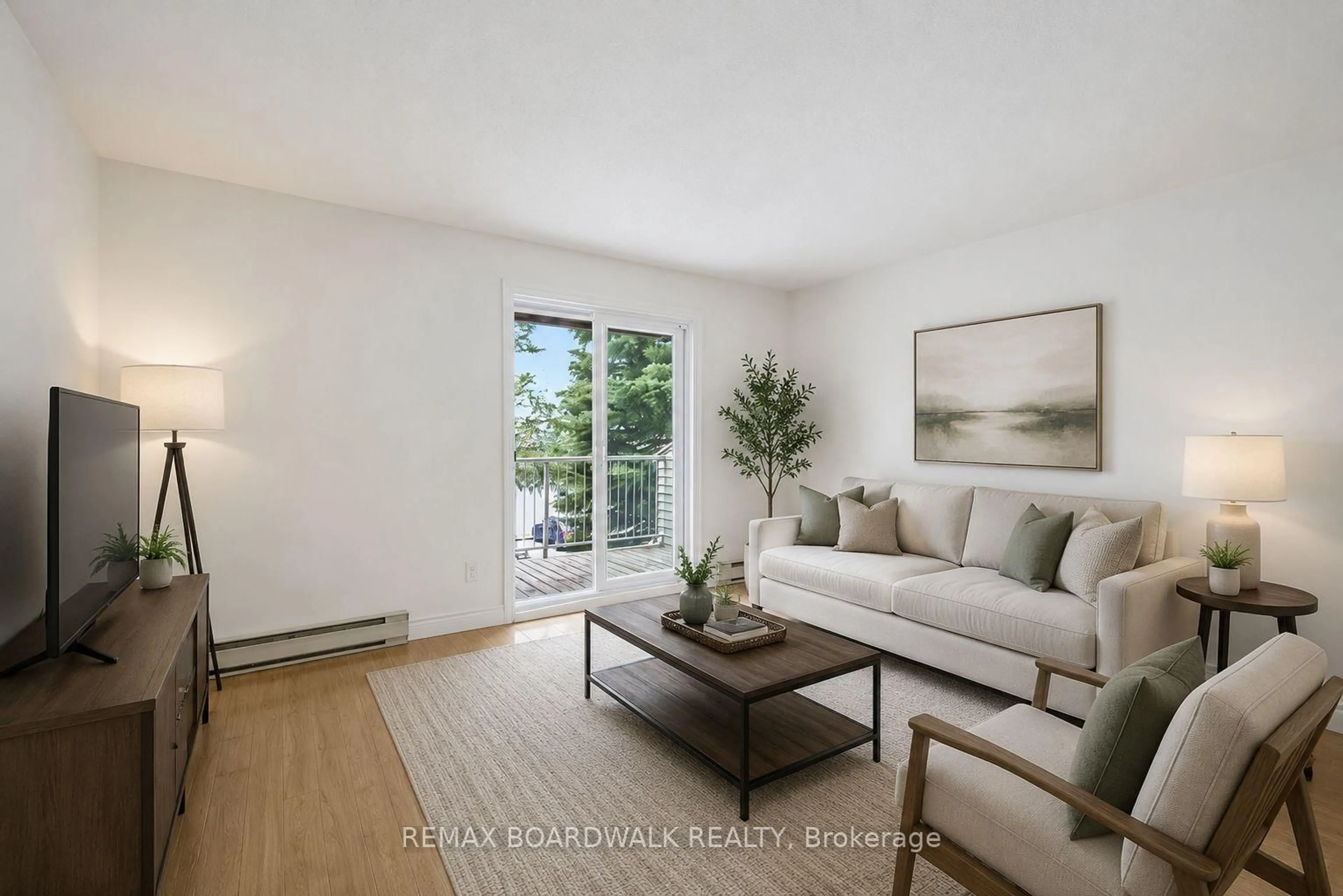 Living room with furniture, wood/laminate floor for 250 Brittany Dr #207, Ottawa Ontario K1K 4M1