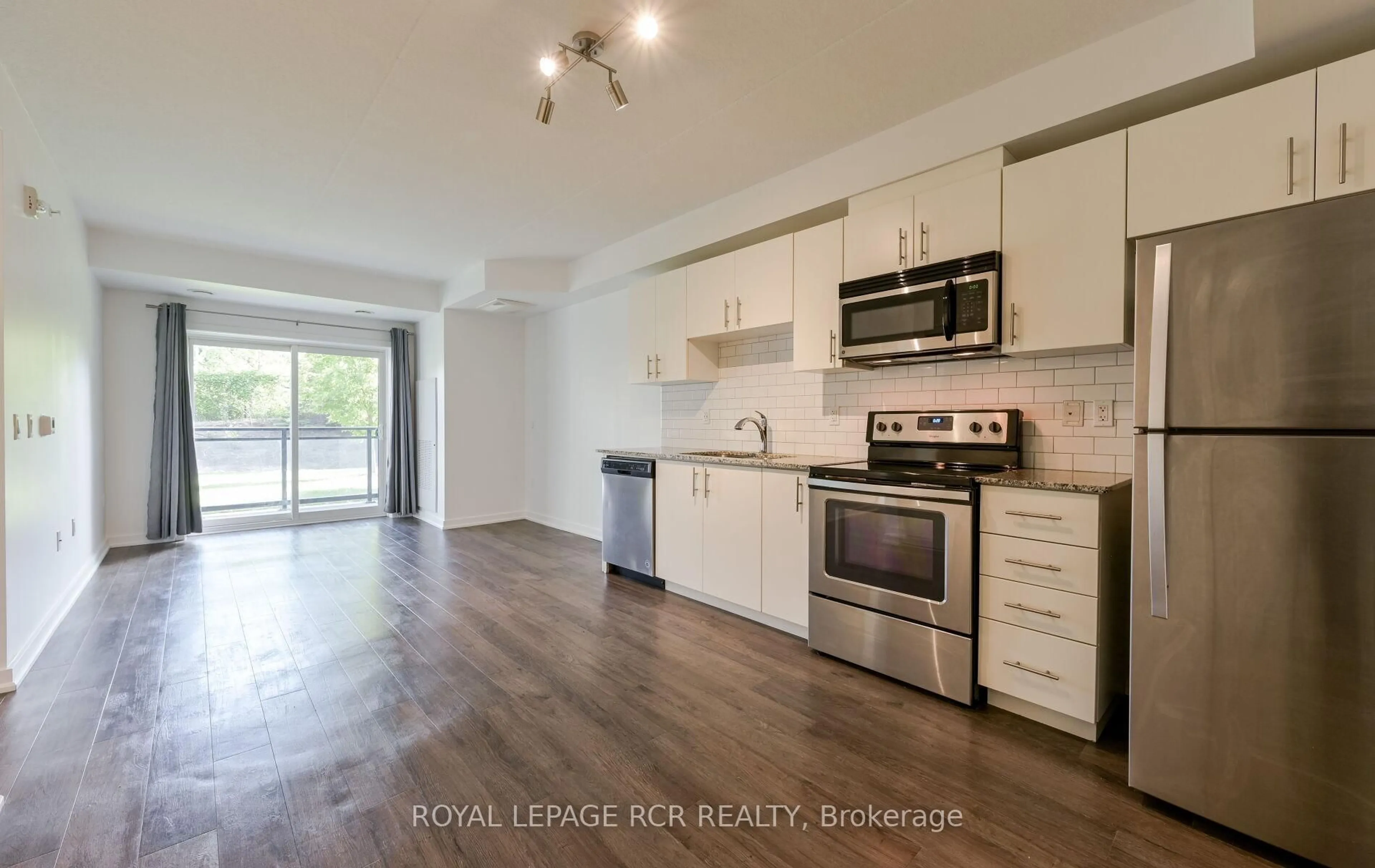 Open concept kitchen, wood/laminate floor for 25 Kay Cres #LL02, Guelph Ontario N1L 0P2