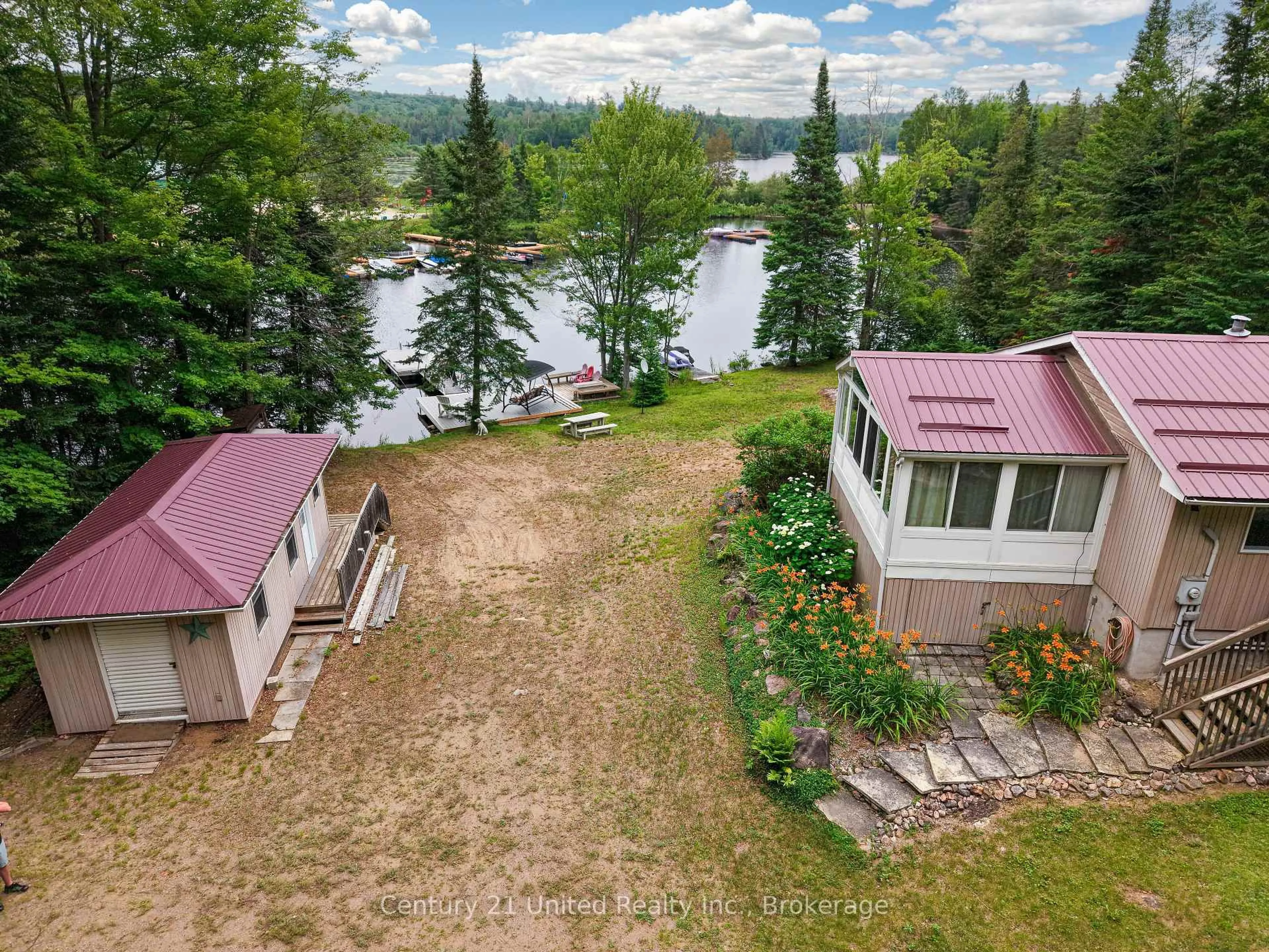 A pic from outside/outdoor area/front of a property/back of a property/a pic from drone, water/lake/river/ocean view for 1047 Redwood Lane, Highlands East Ontario K0L 1C0