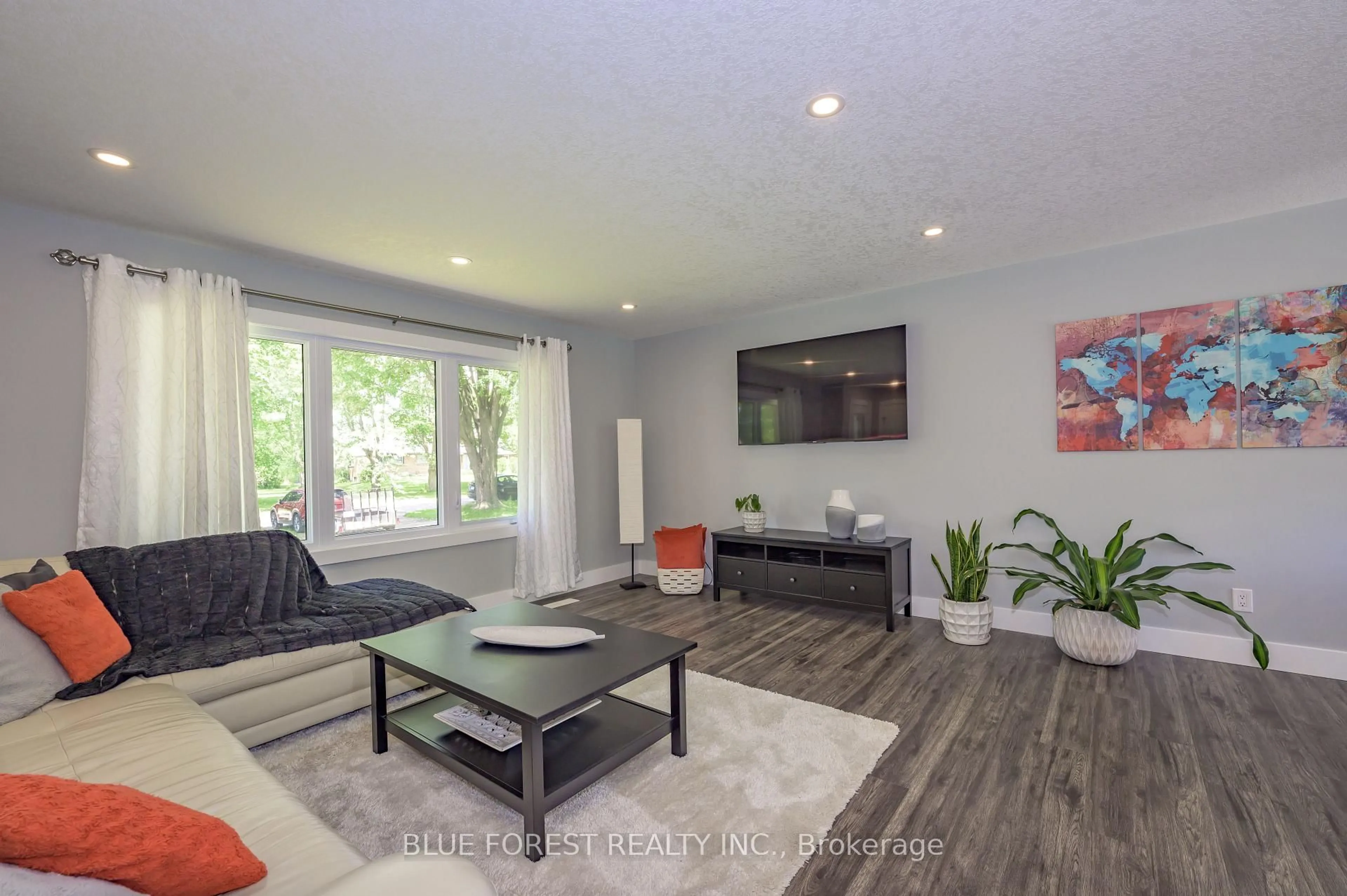 Living room with furniture, wood/laminate floor for 966 Glenbanner Rd, London South Ontario N6E 1N2