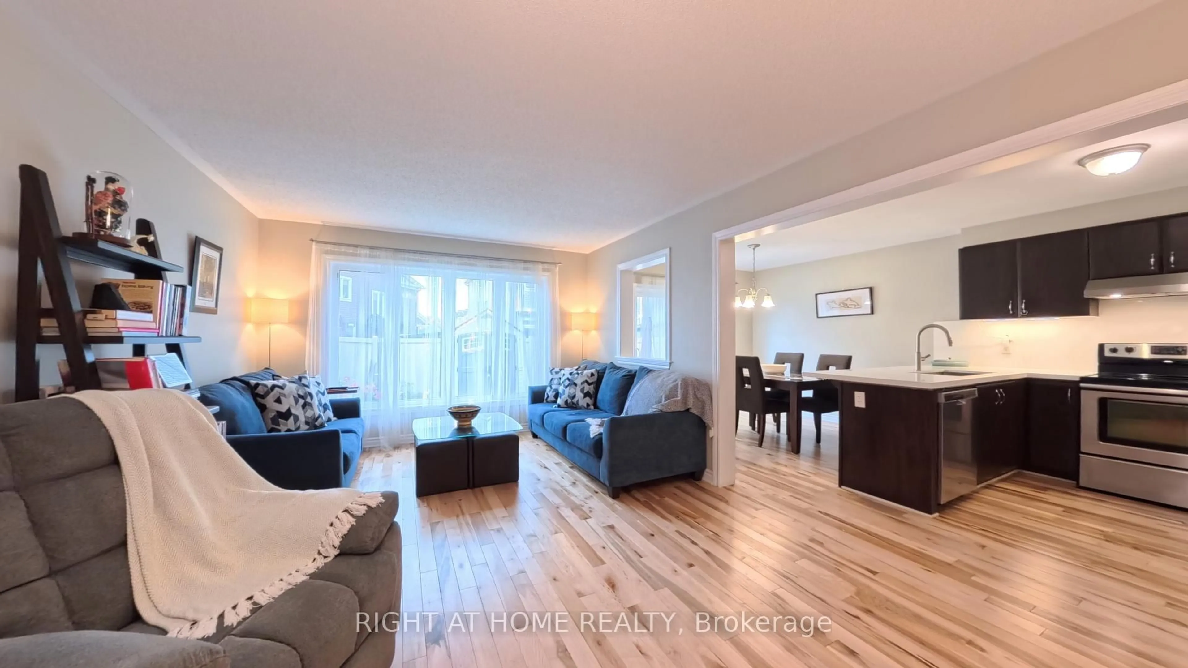 Living room with furniture, wood/laminate floor for 566 Dundonald Dr, Ottawa Ontario K2J 5X1