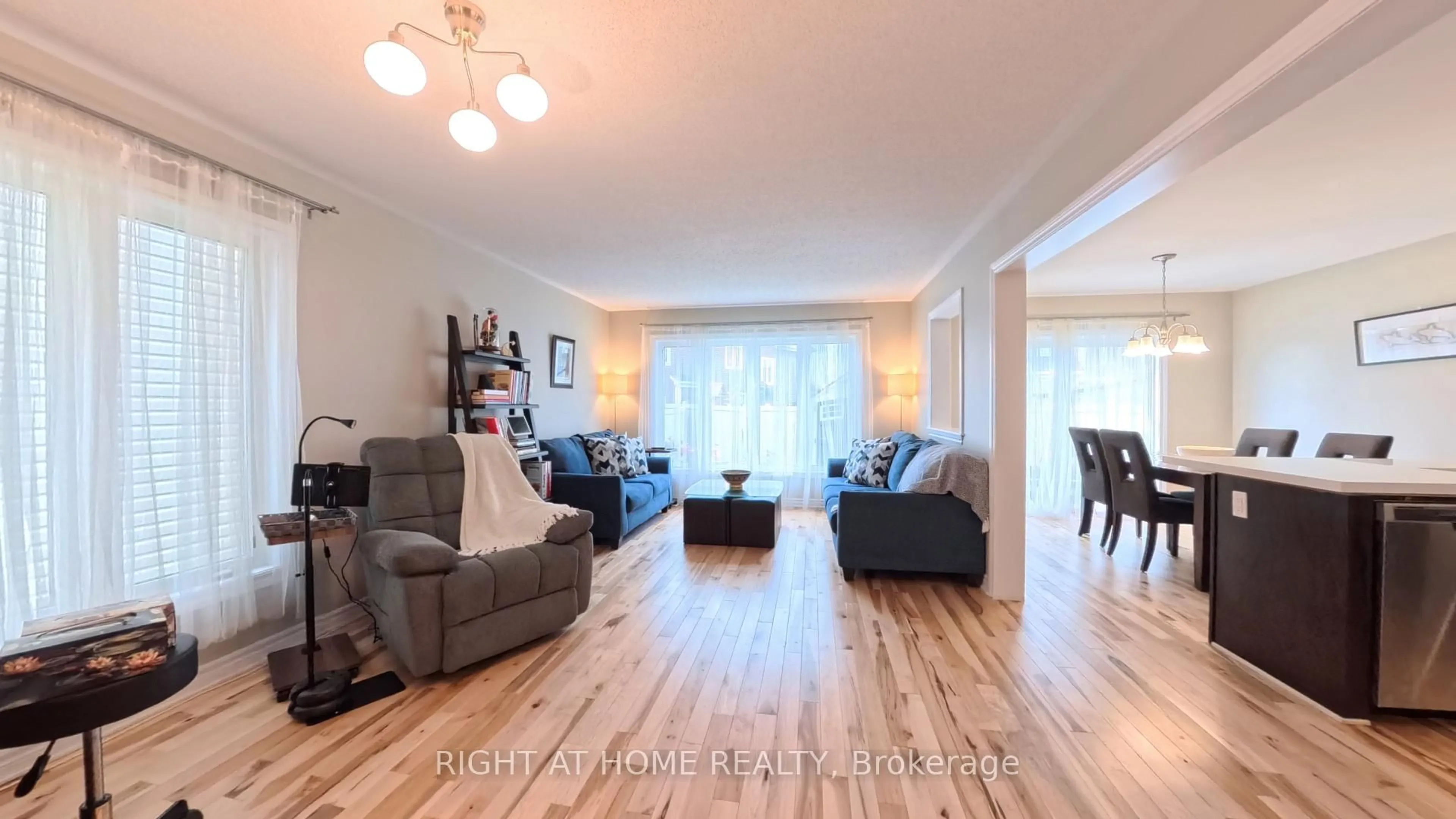 Living room with furniture, wood/laminate floor for 566 Dundonald Dr, Ottawa Ontario K2J 5X1