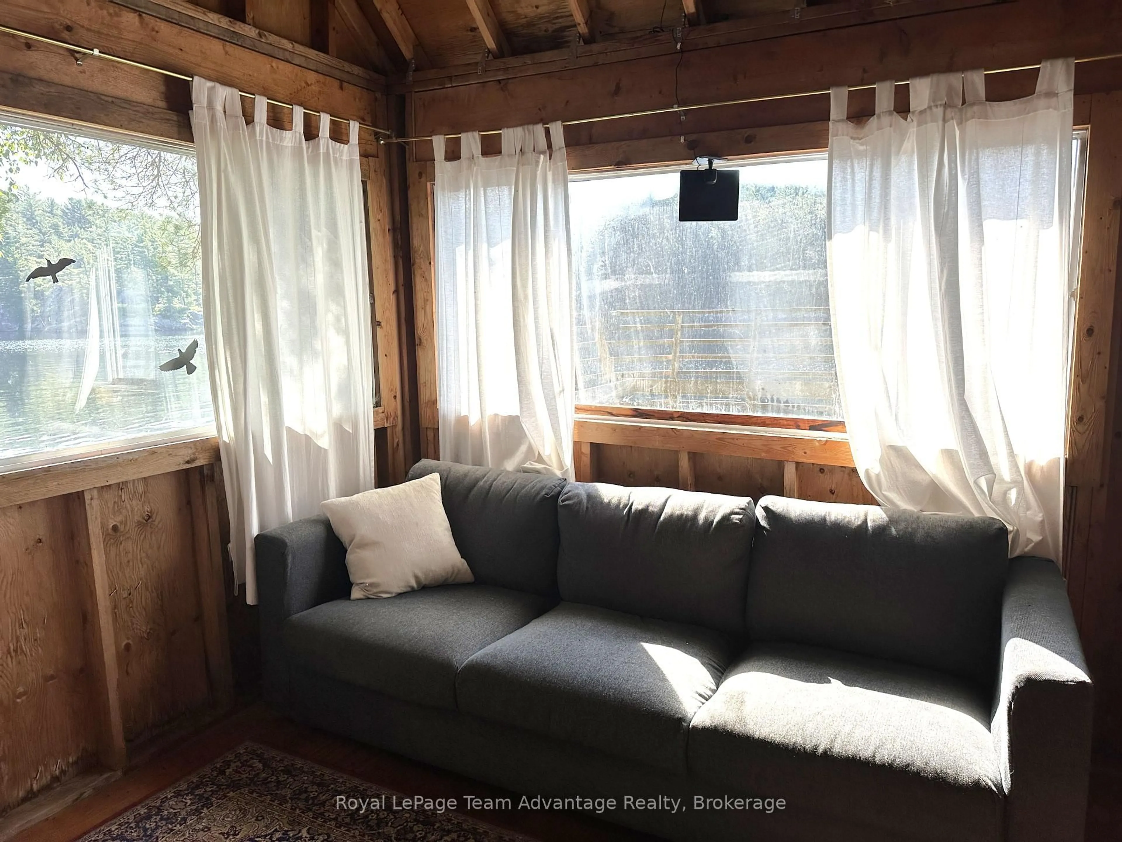 Living room with furniture, wood/laminate floor for 9075 Harris Lake Water, Whitestone Ontario P0A 1G0