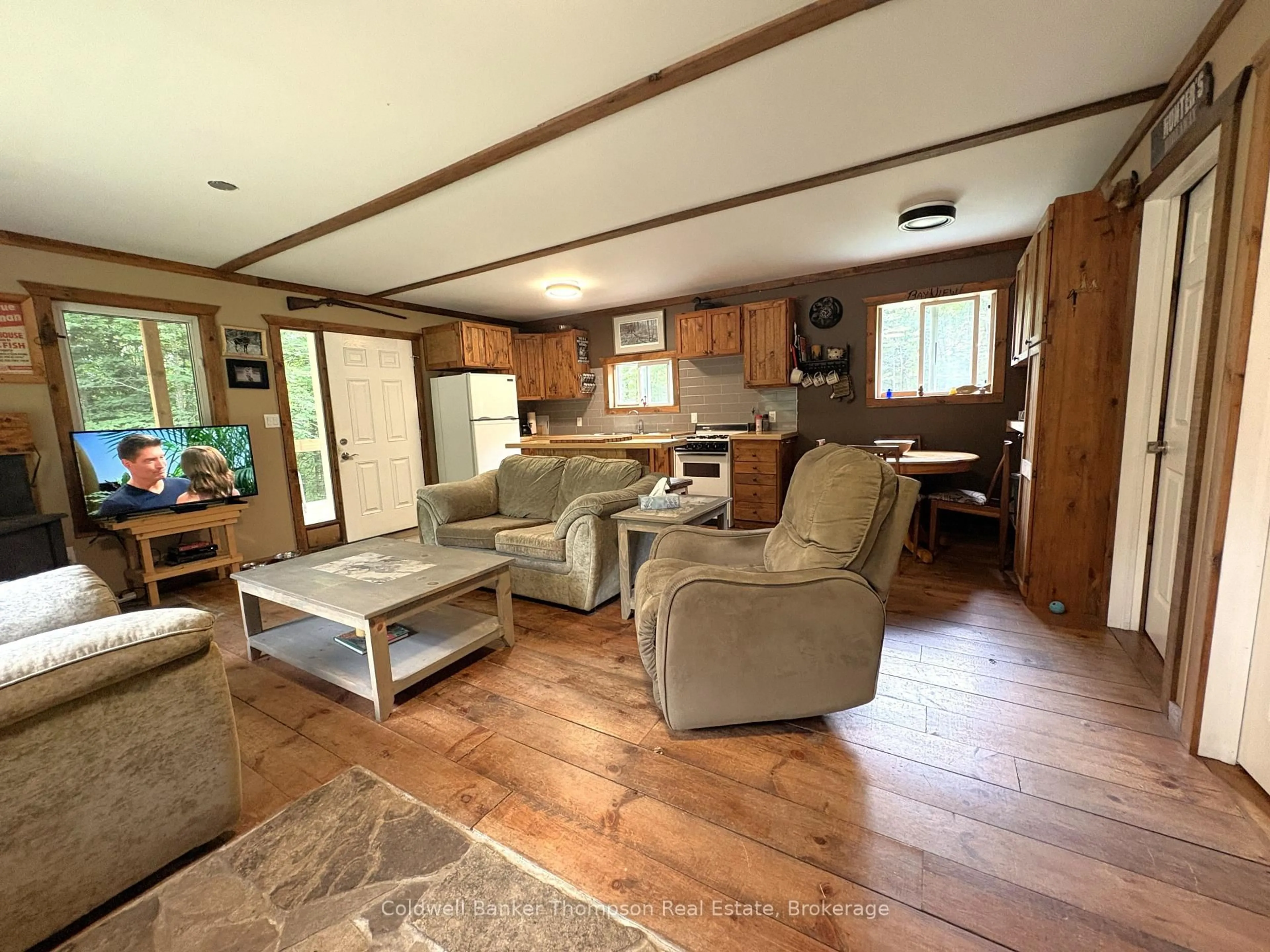 Living room with furniture, wood/laminate floor for 3274 Eagle Lake Rd, Parry Sound Remote Area Ontario P0A 1X0