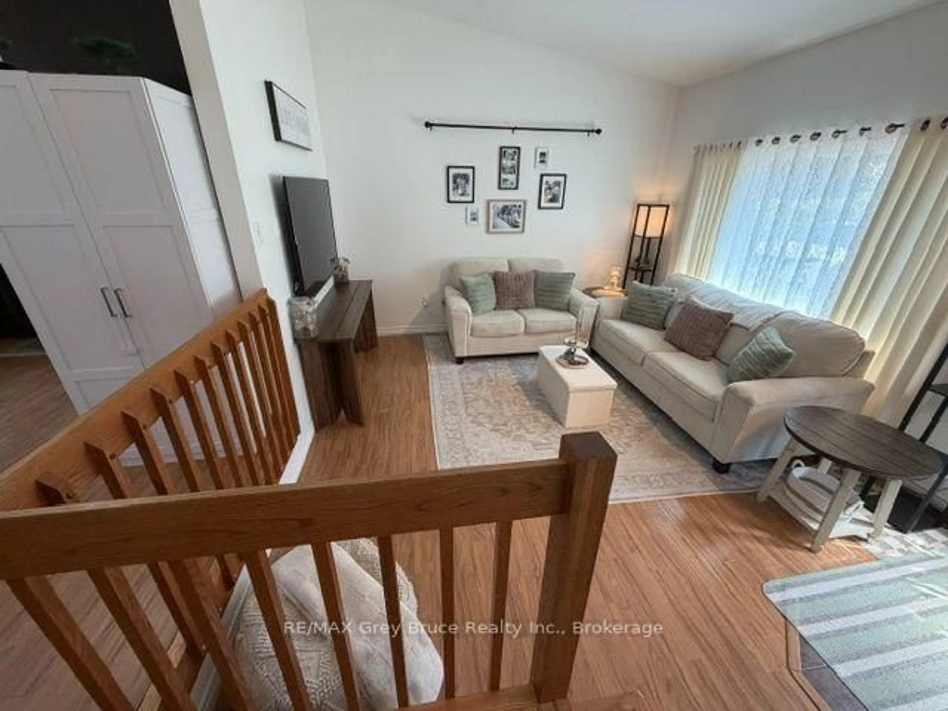 Living room with furniture, wood/laminate floor for 320 8th A Ave, Owen Sound Ontario N4K 6L3