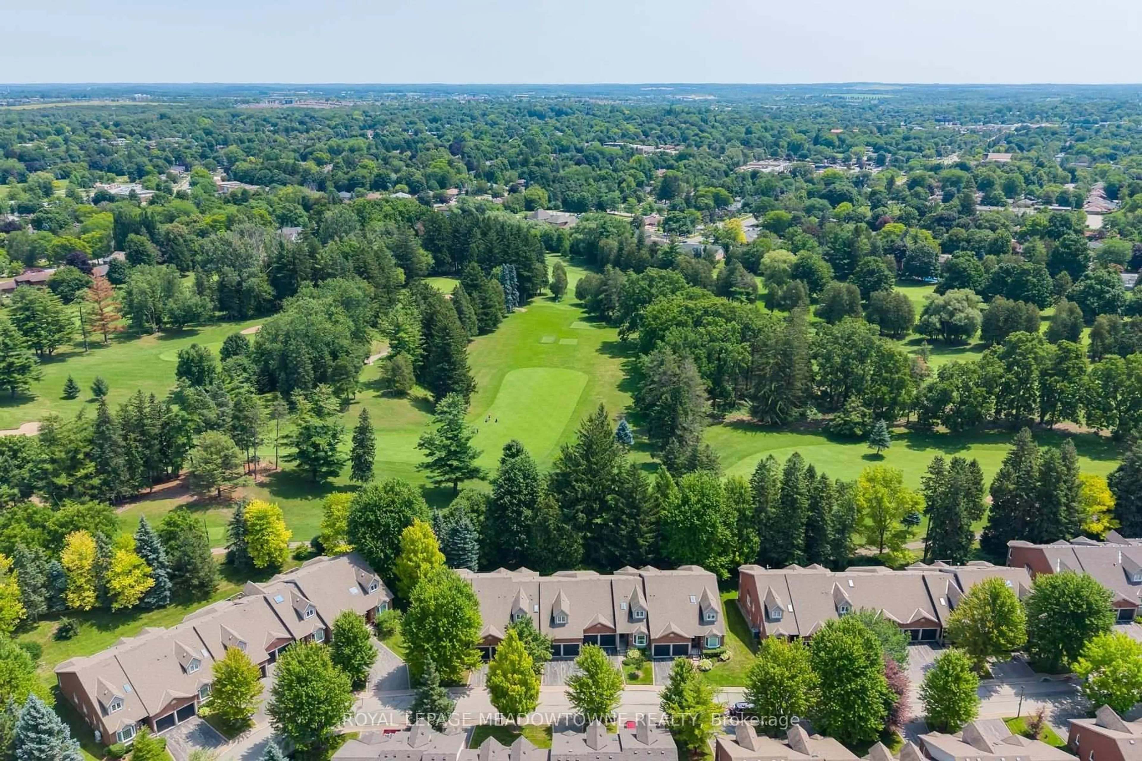 A pic from outside/outdoor area/front of a property/back of a property/a pic from drone, forest/trees view for 12 Fairway Lane, Guelph Ontario N1E 7A9