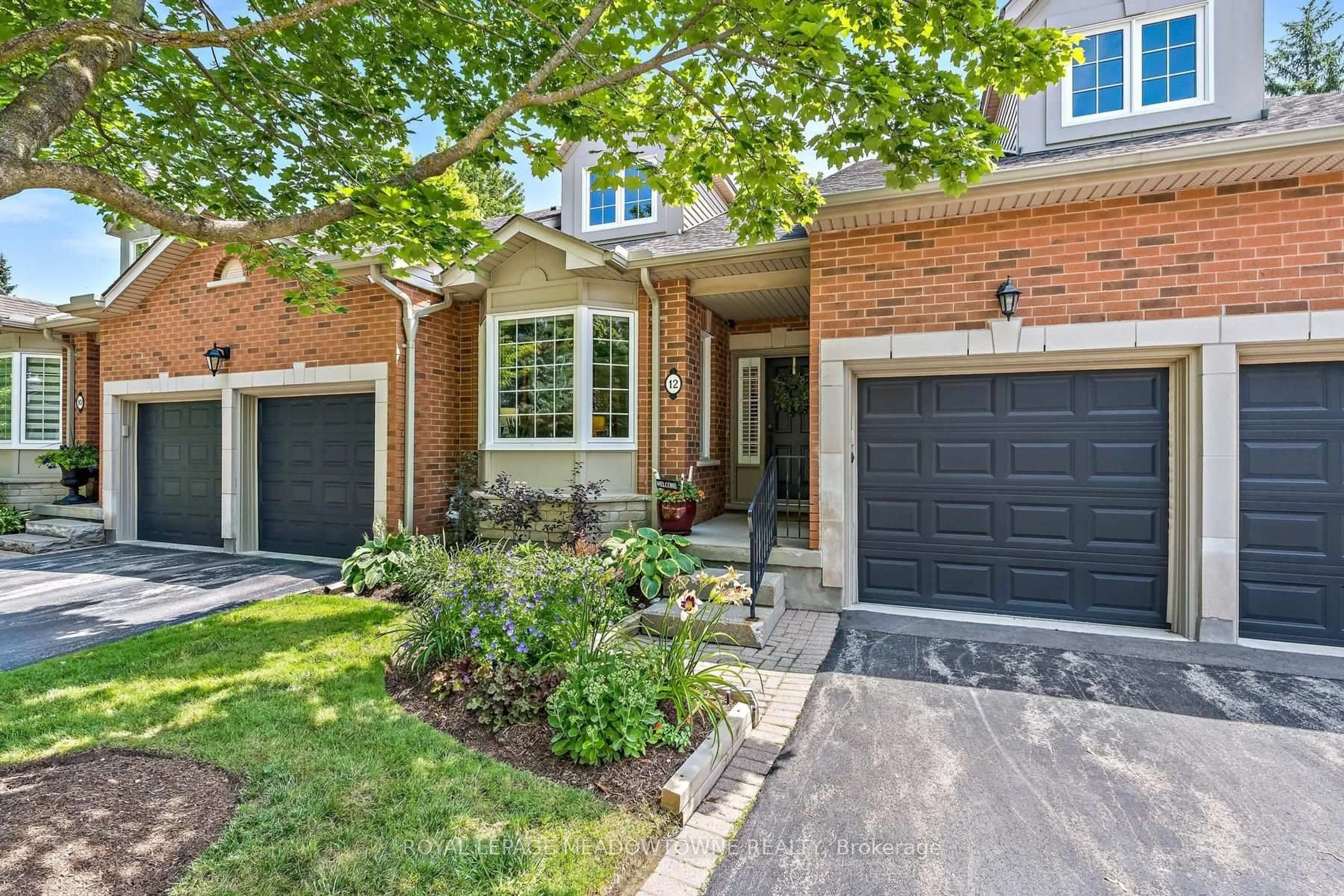 Home with brick exterior material, street for 12 Fairway Lane, Guelph Ontario N1E 7A9