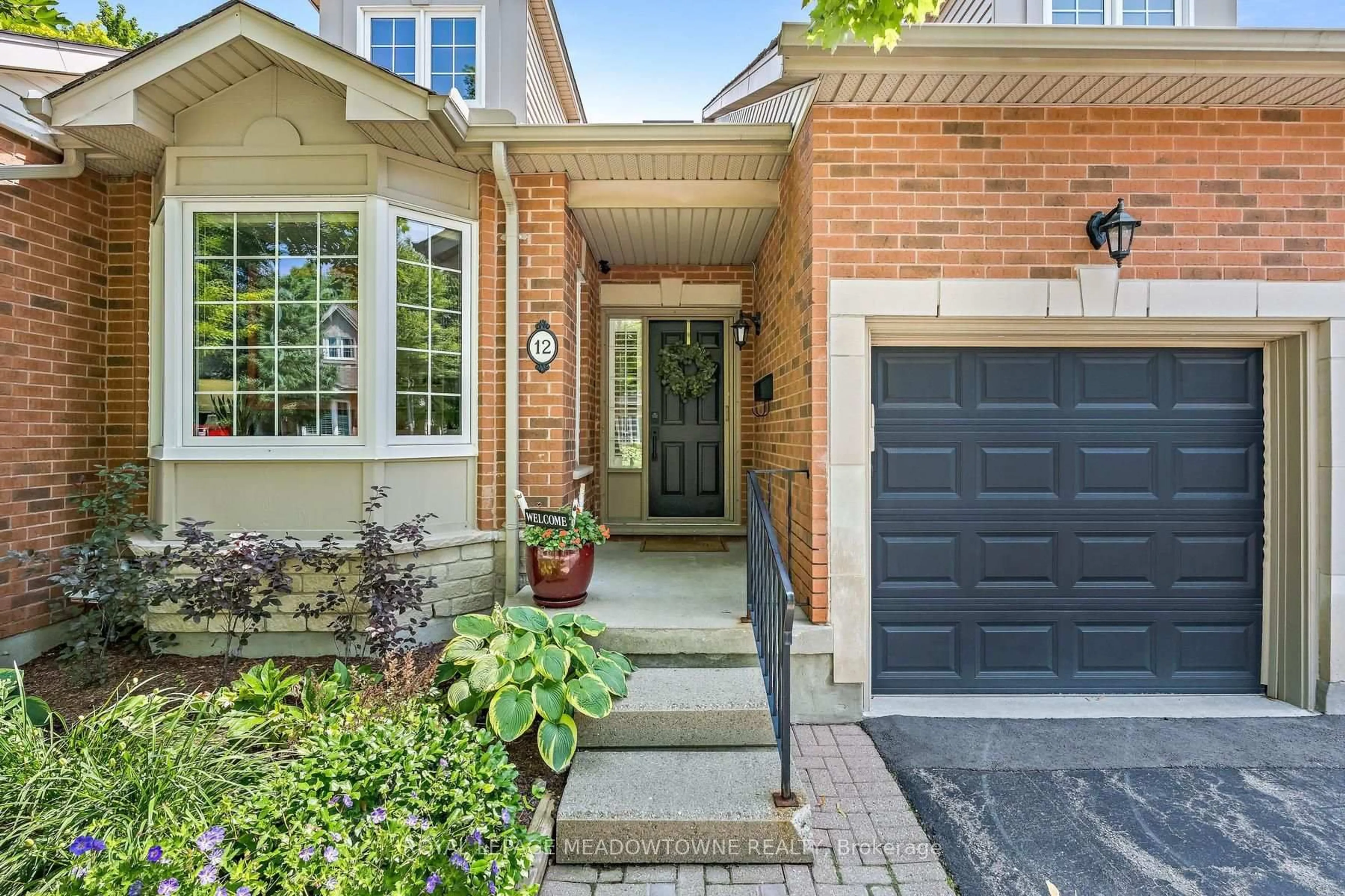 Home with brick exterior material, street for 12 Fairway Lane, Guelph Ontario N1E 7A9