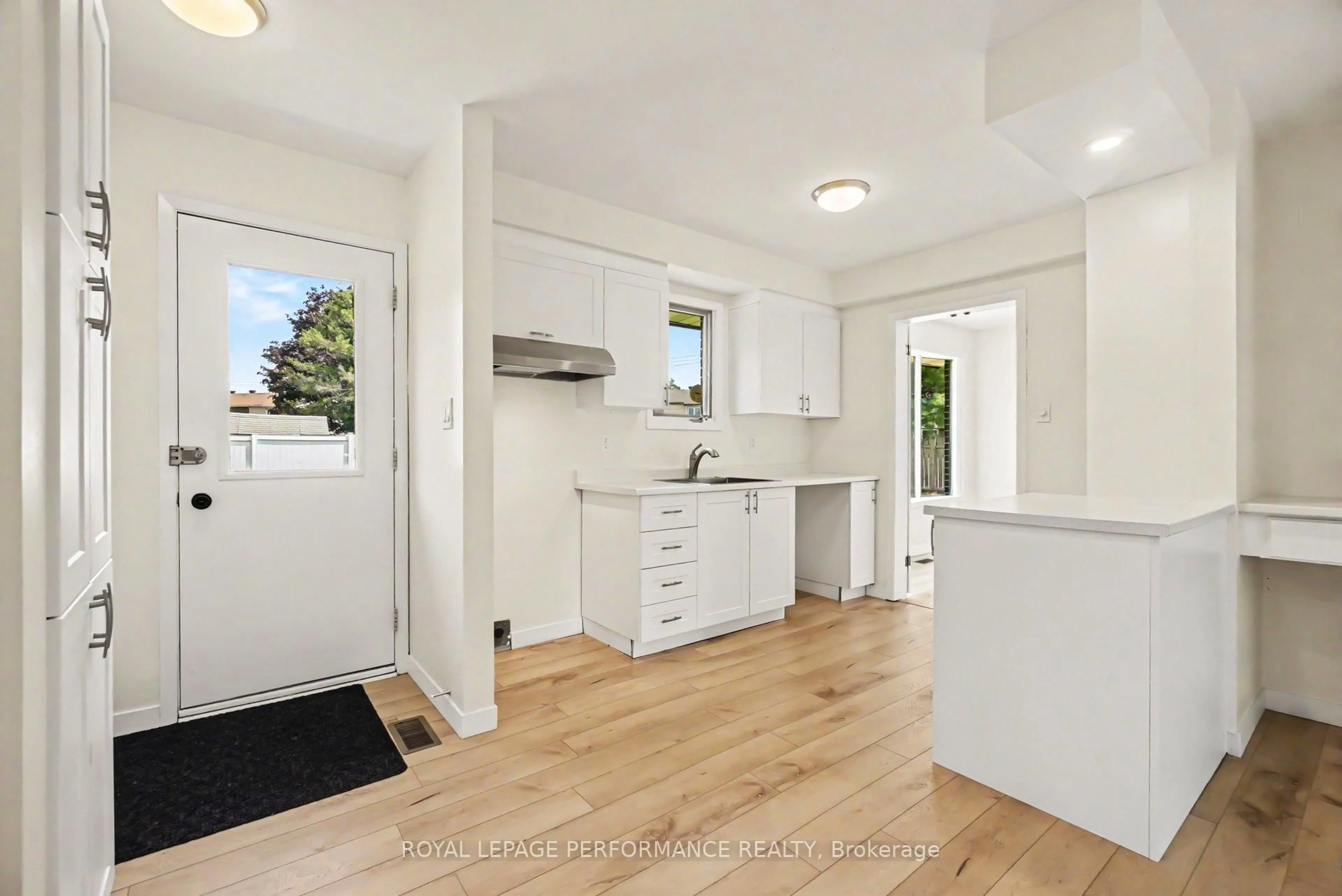 Open concept kitchen, wood/laminate floor for 13 Elvaston Ave, Ottawa Ontario K2G 3T2