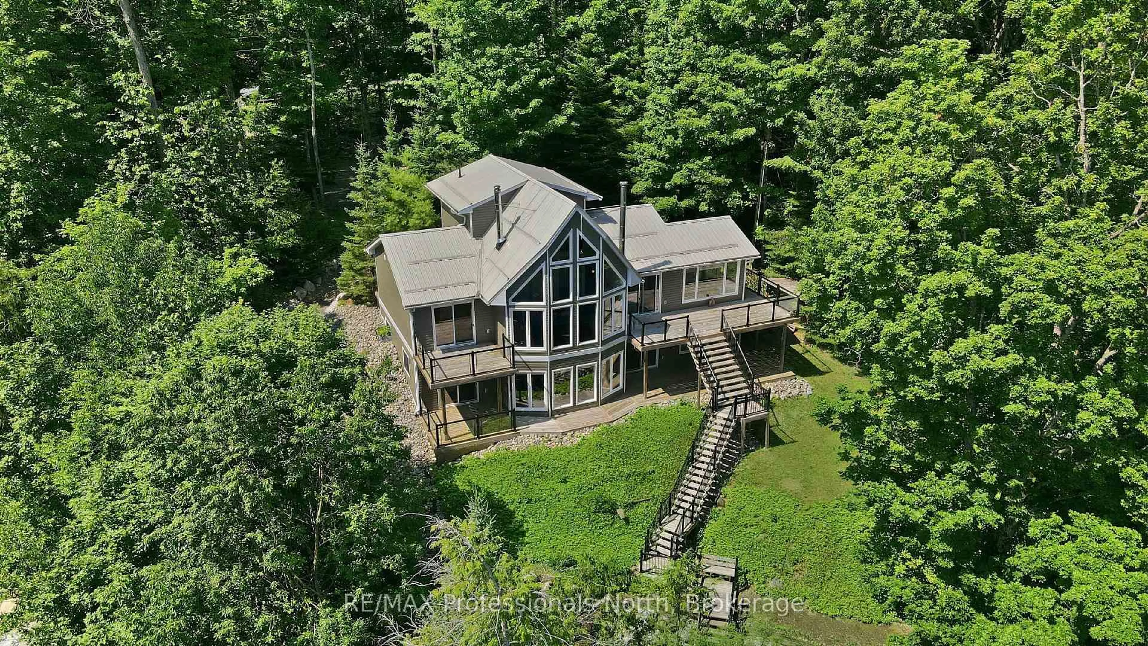 A pic from outside/outdoor area/front of a property/back of a property/a pic from drone, water/lake/river/ocean view for 1114 Miskwabi Lake Rd, Dysart et al Ontario K0M 1S0