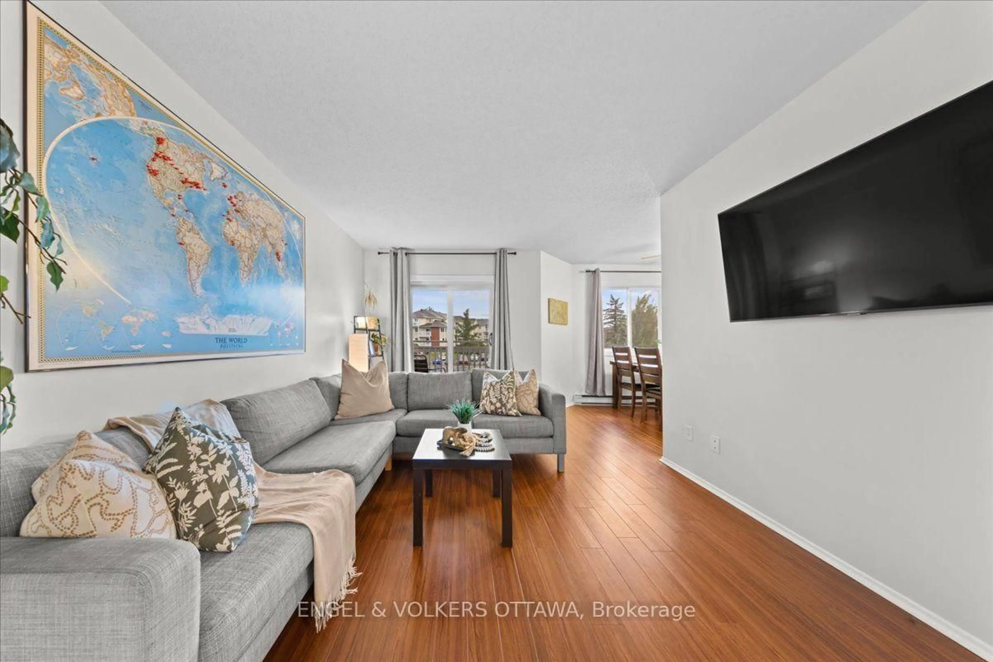 Living room with furniture, wood/laminate floor for 268 Lorry Greenberg Dr #107, Ottawa Ontario K1T 3K1