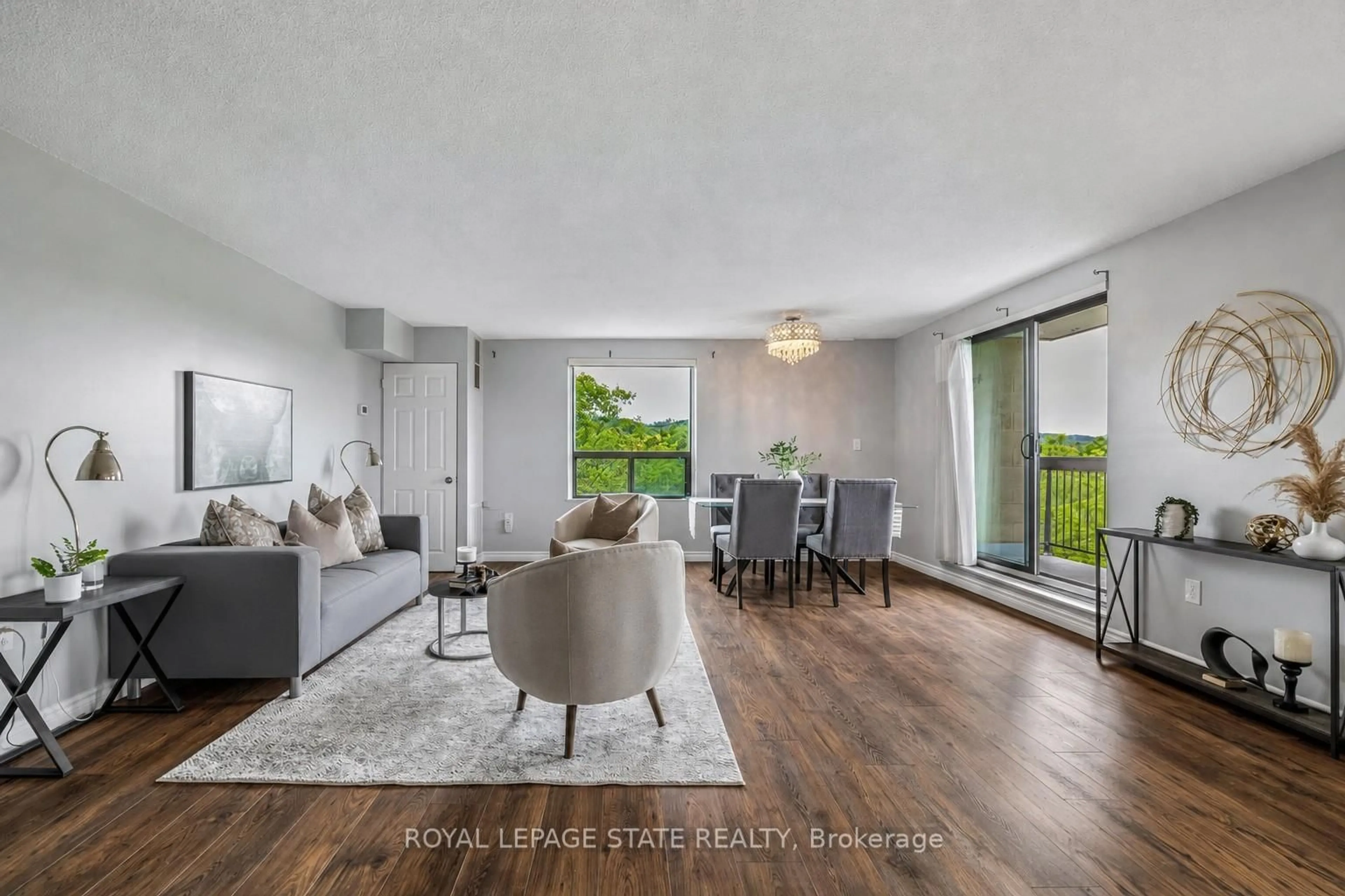 Living room with furniture, wood/laminate floor for 966 Queenston Rd #605, Hamilton Ontario L8G 1B7
