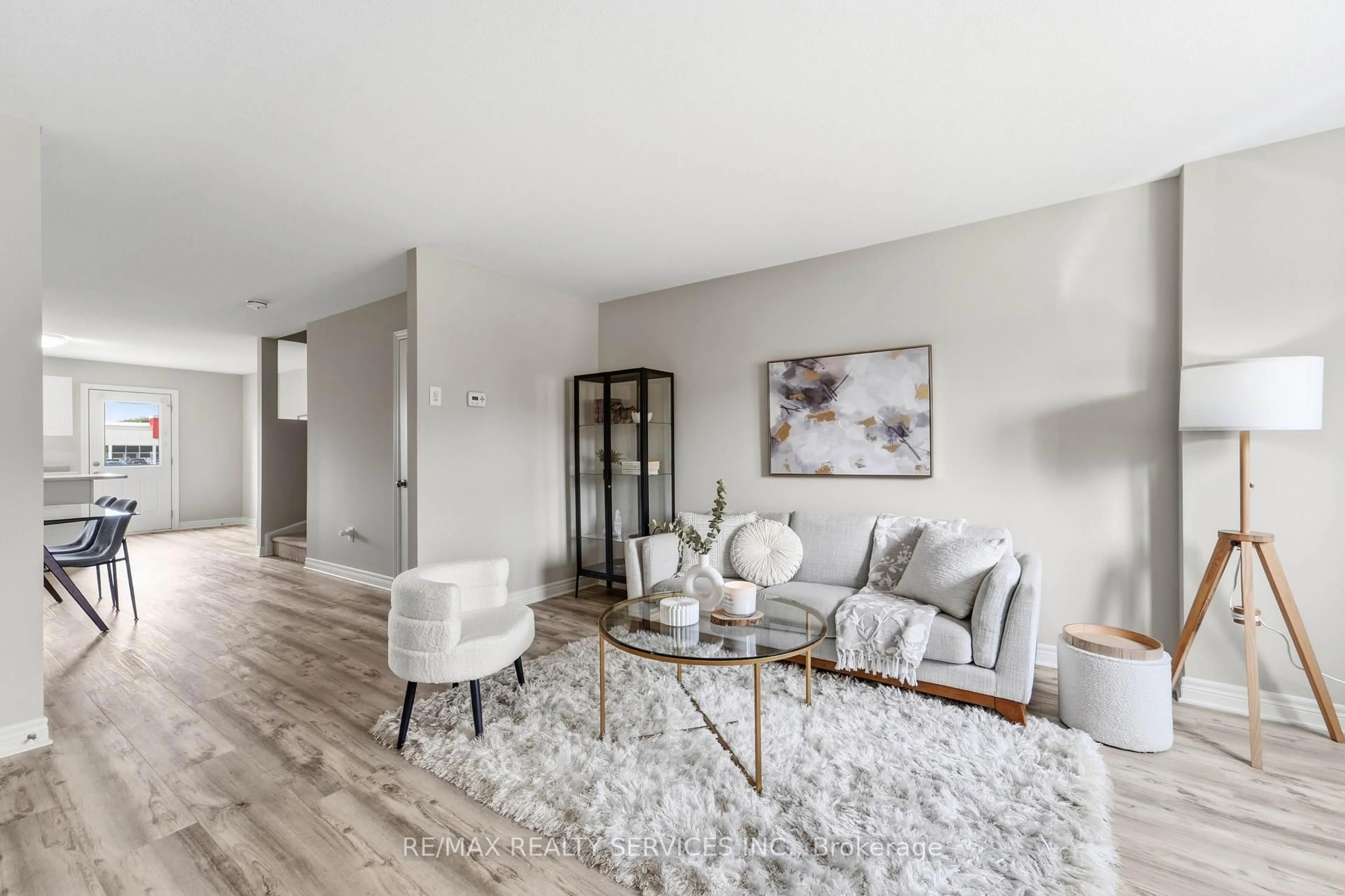 Living room with furniture, wood/laminate floor for 7768 Ascot Circ #5, Niagara Falls Ontario L2H 3P9