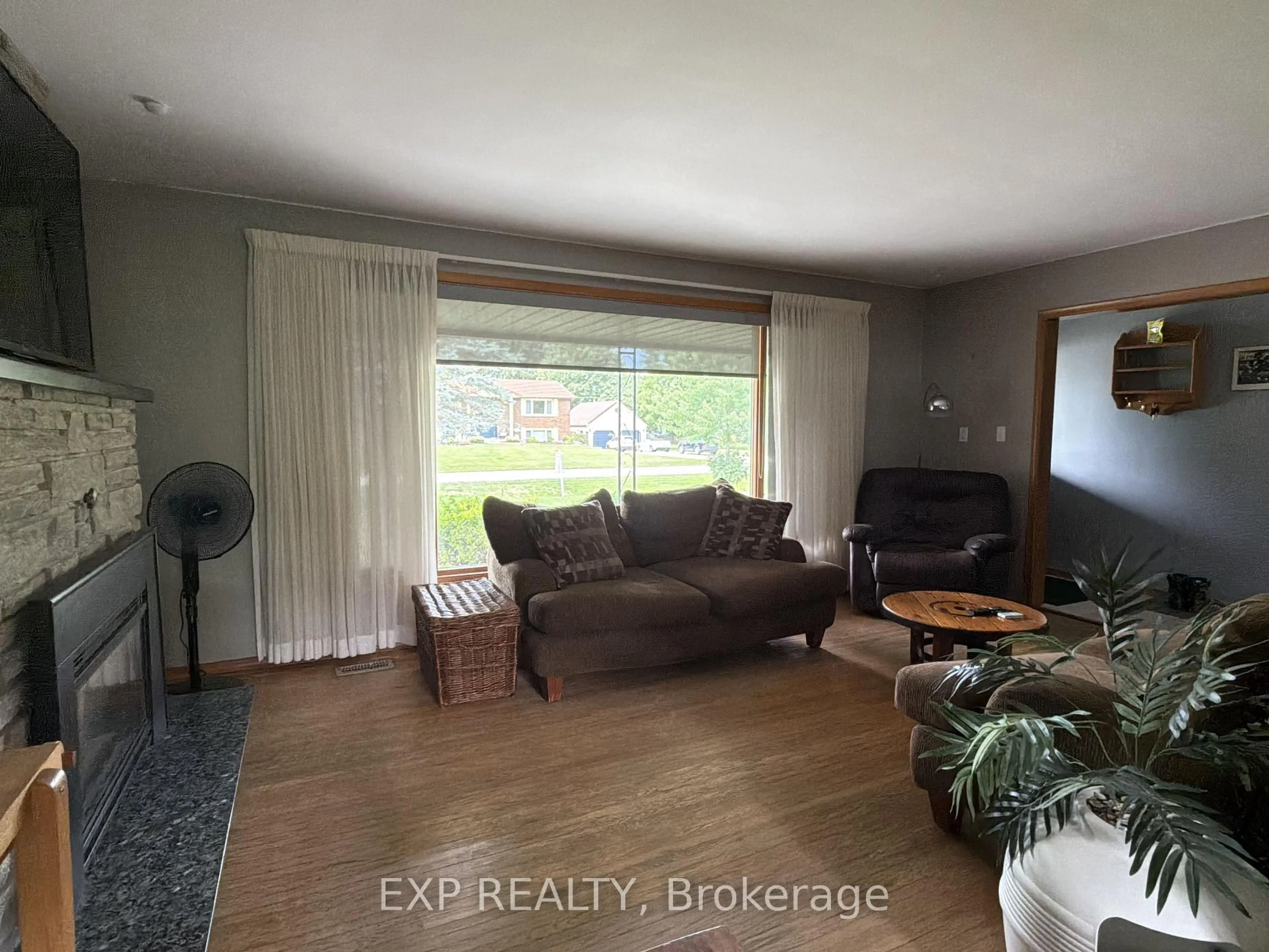 Living room with furniture, wood/laminate floor for 120 Huron Ave, Middlesex Centre Ontario N0L 1R0