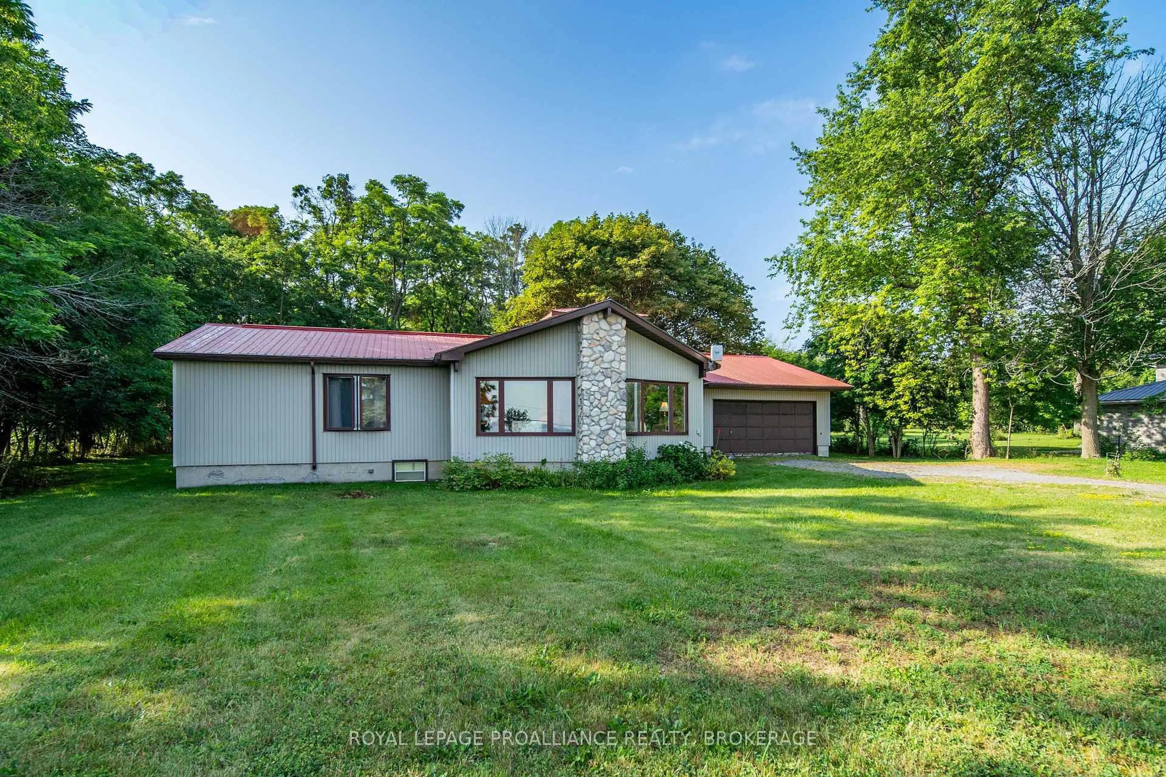 A pic from outside/outdoor area/front of a property/back of a property/a pic from drone, street for 1039 Highway 96, Wolfe Island Ontario K0H 2Y0