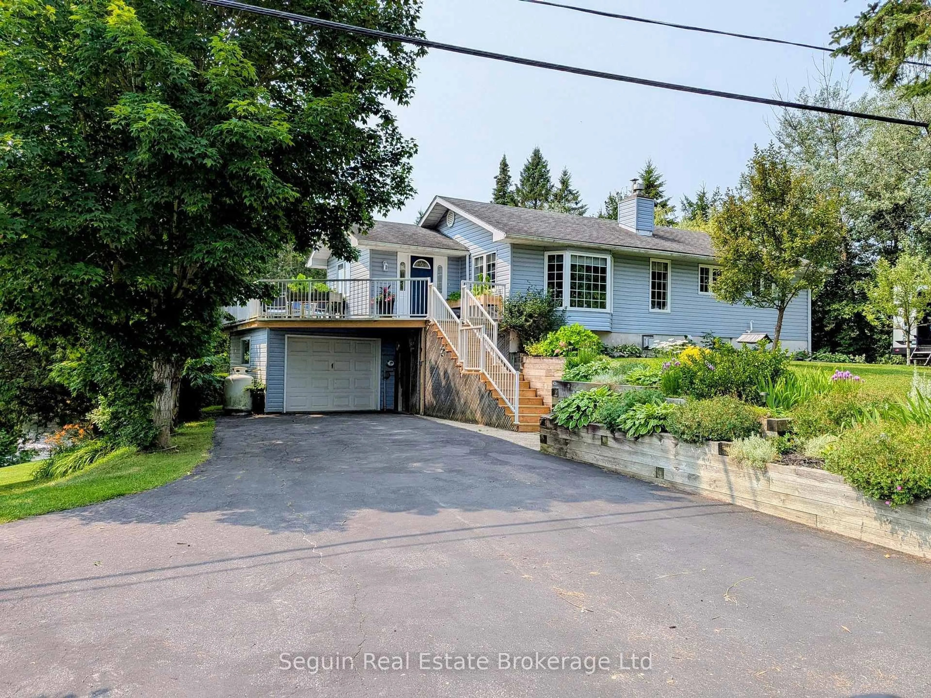A pic from outside/outdoor area/front of a property/back of a property/a pic from drone, street for 1091 HIGHWAY 518 Highway, Seguin Ontario P2A 0B6