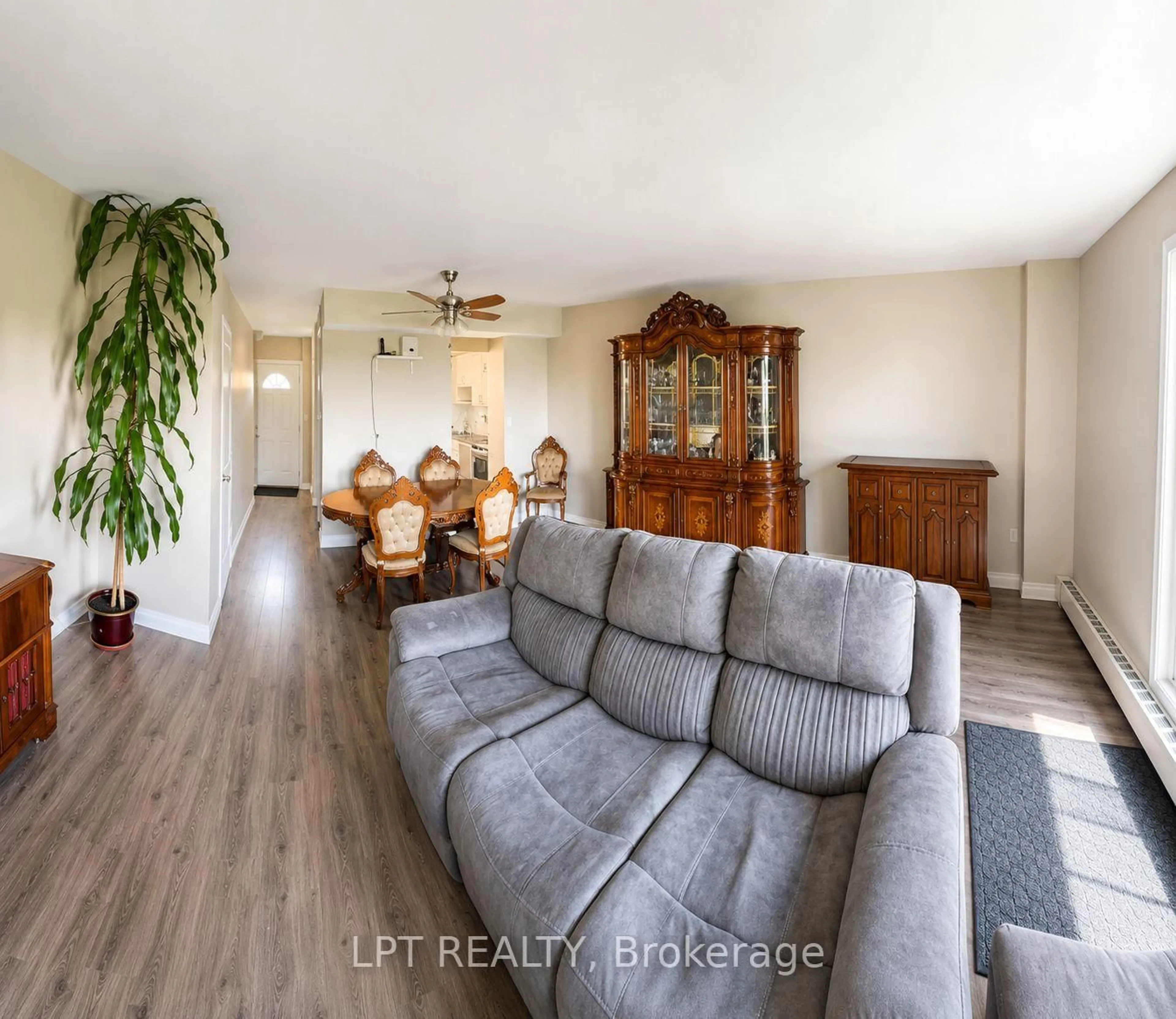 Living room with furniture, wood/laminate floor for 350 Quigley Rd #512, Hamilton Ontario L8K 5N2