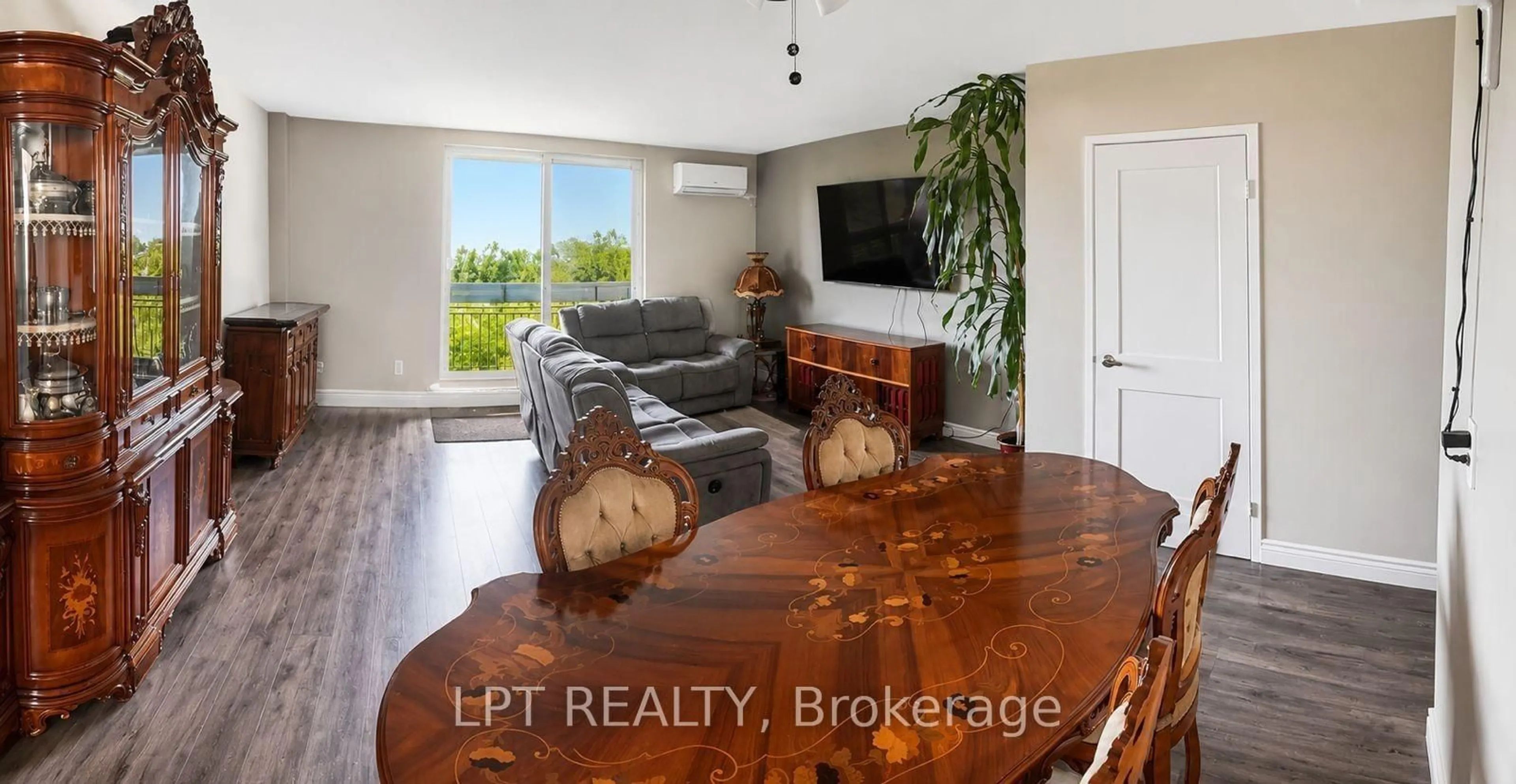 Living room with furniture, wood/laminate floor for 350 Quigley Rd #512, Hamilton Ontario L8K 5N2